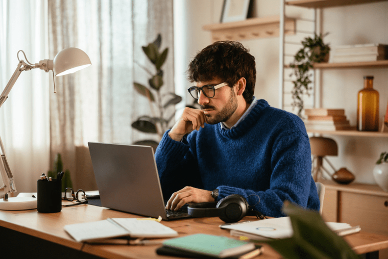 A man sitting at a desk at his home office