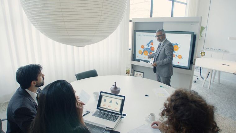 A diverse group of professionals collaborating in an office setting, emphasizing teamwork and cooperation in navigating Section 301 tariff exclusions.