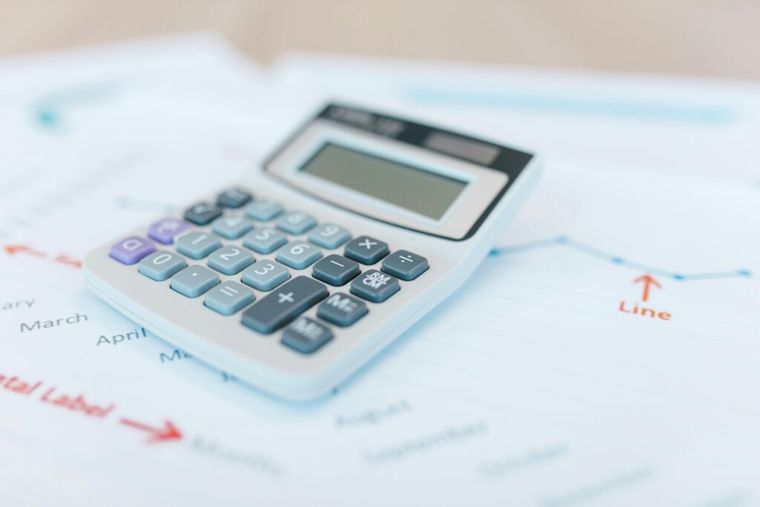 Image of a calculator on tax paperwork.