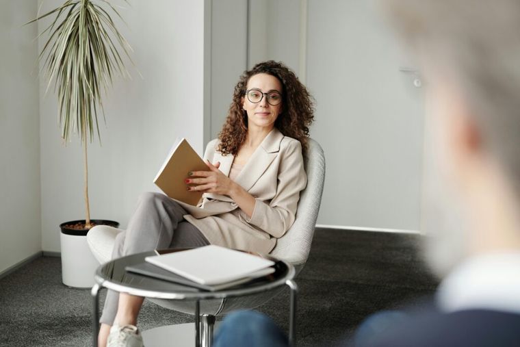 A professional holding a notebook in a modern workspace—symbolizing the in-depth analysis tax advisors must perform to apply new OBBB provisions like Trump Accounts and expanded SALT caps.