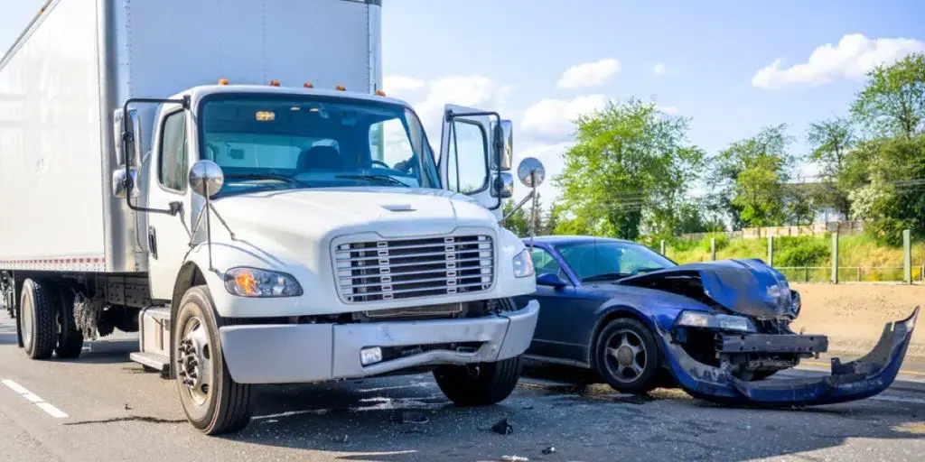 an image of a damaged truck and car