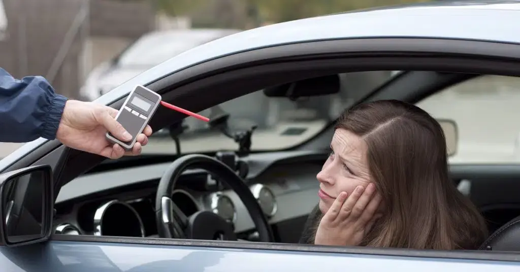 an image of a drunk woman inside her car