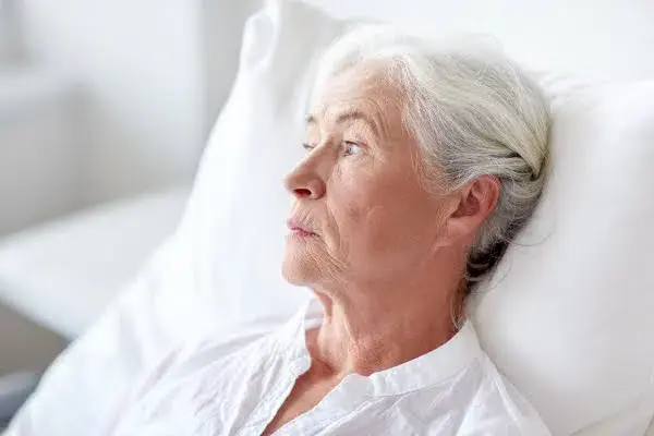 an image of an old woman in bed