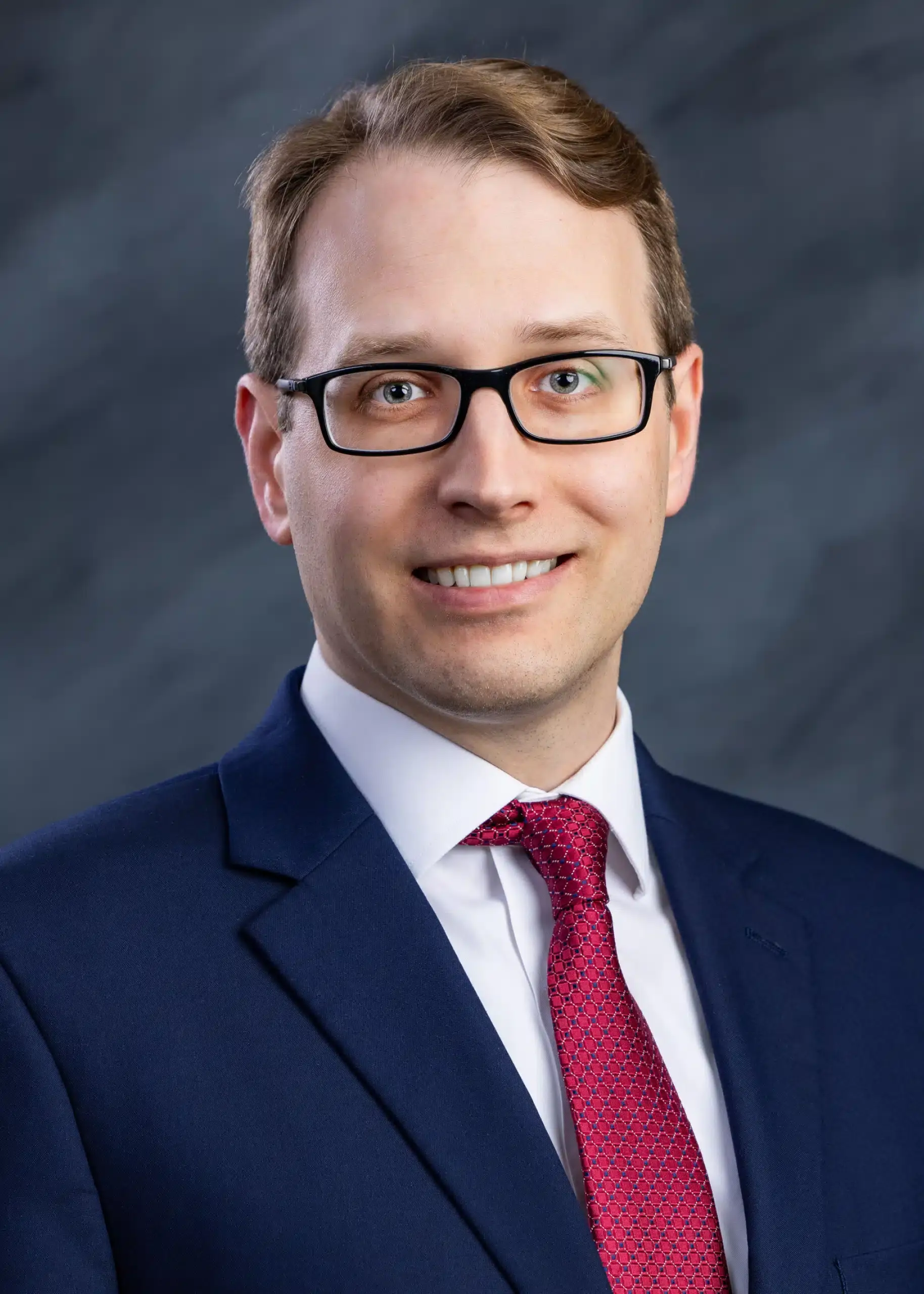 an image of a person wearing a suit and glasses