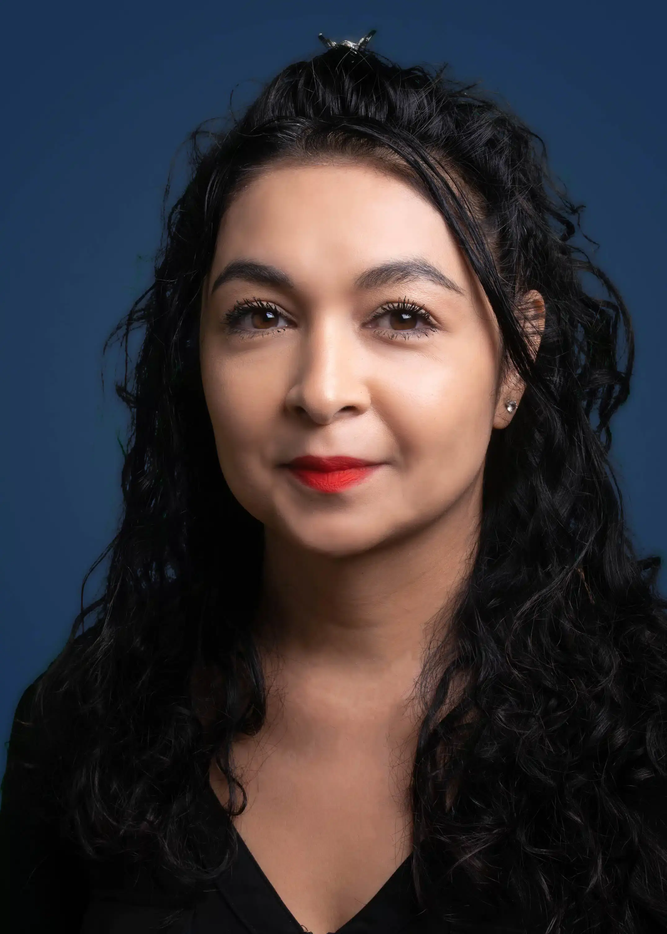 a person with long black hair and red lipstick