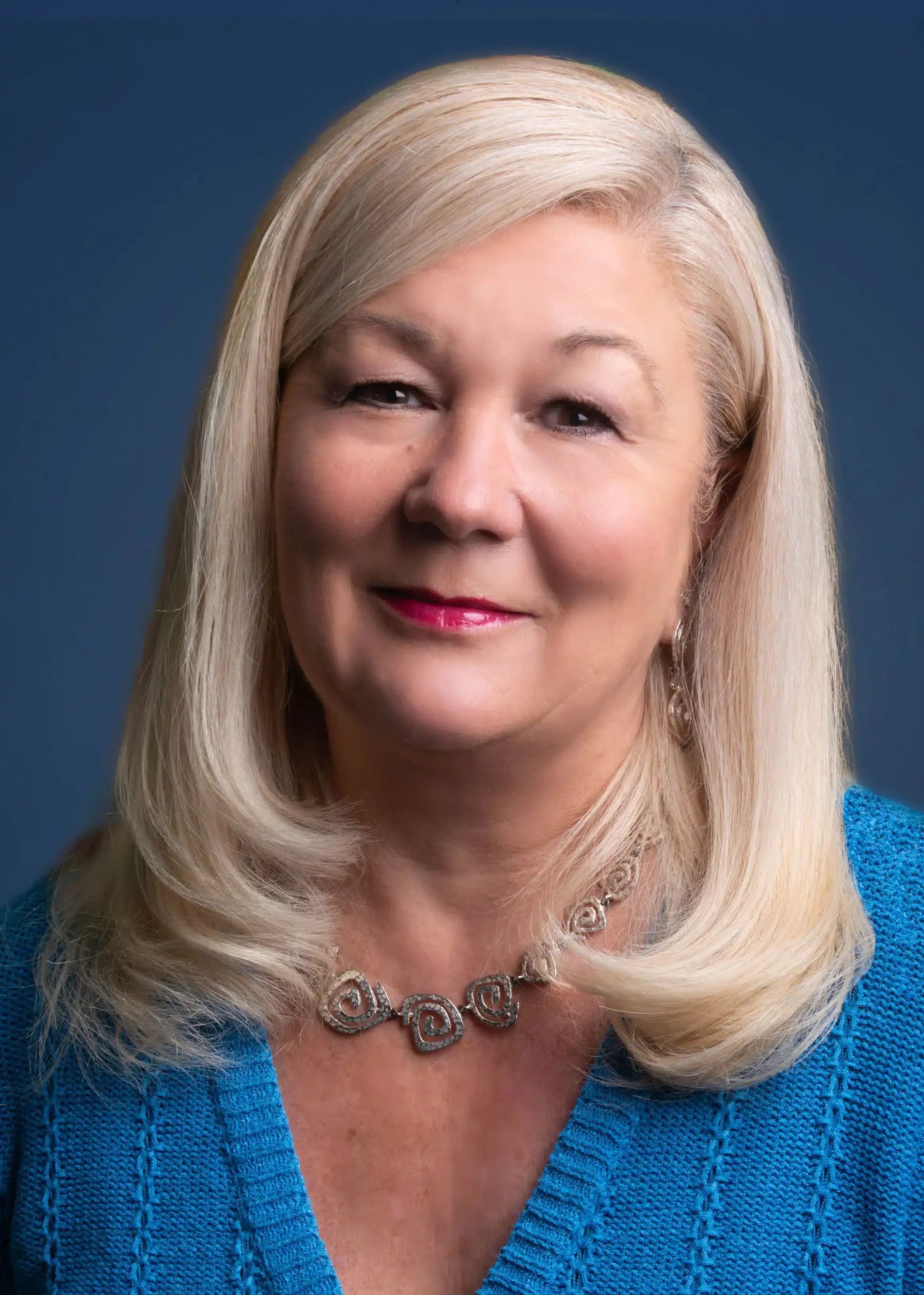 a person with blonde hair wearing a blue shirt