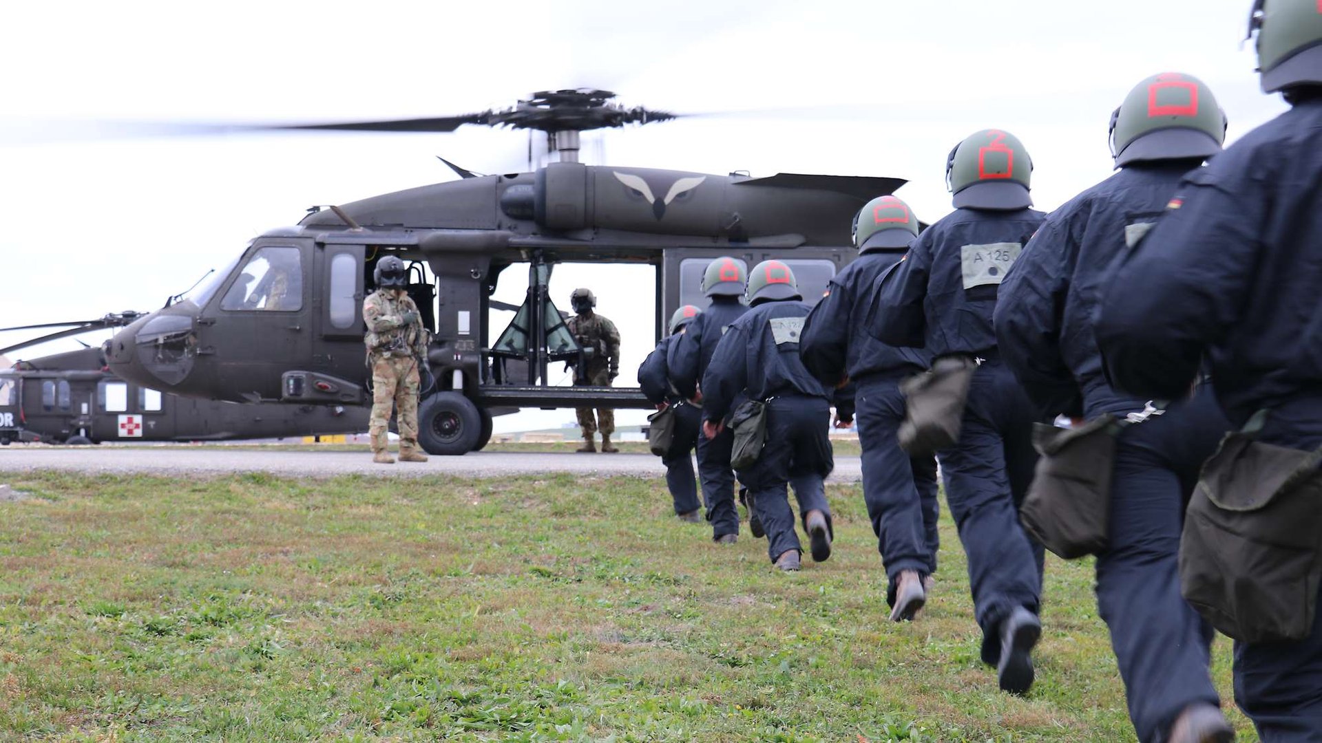 Approaching and safely boarding an American Black Hawk helicopter with the engine running requires instruction and practice