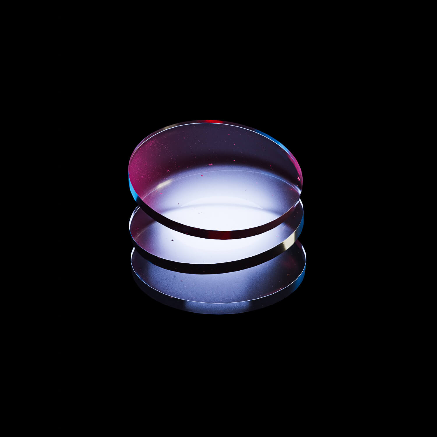 Three frosted glass discs with red and blue light cast onto them against a dark background