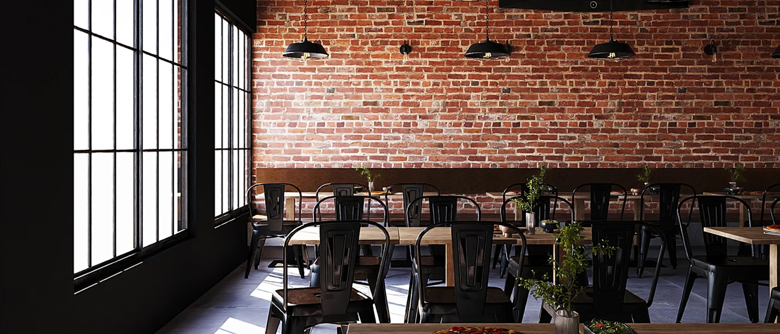 01 — The room by day. Brick holds the morning heat and the window spreads it; the tables fill without switching anything on.