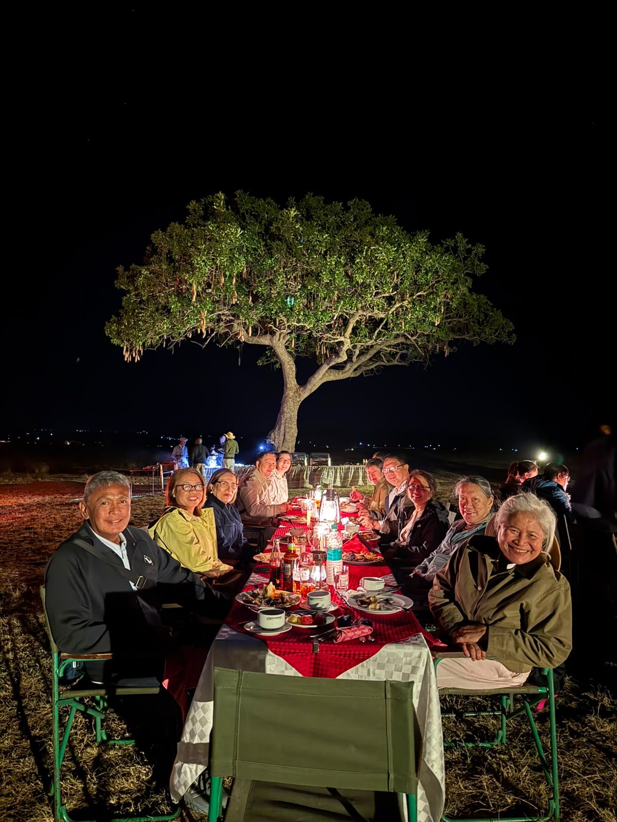 Corporate incentive travel group enjoying a private bush dinner during a MICE programme in Kenya