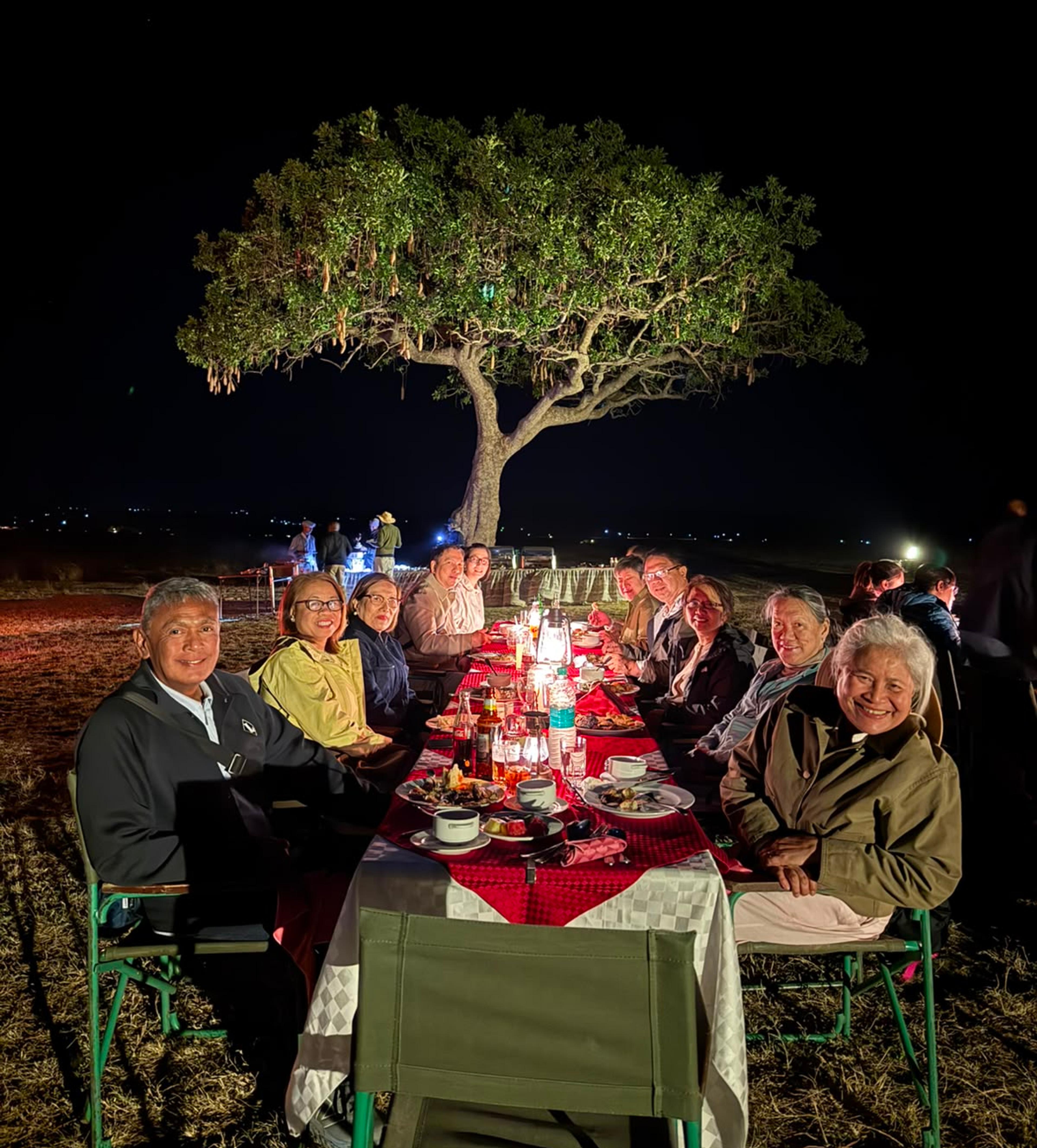 Corporate incentive travel group enjoying a private bush dinner during a MICE programme in Kenya