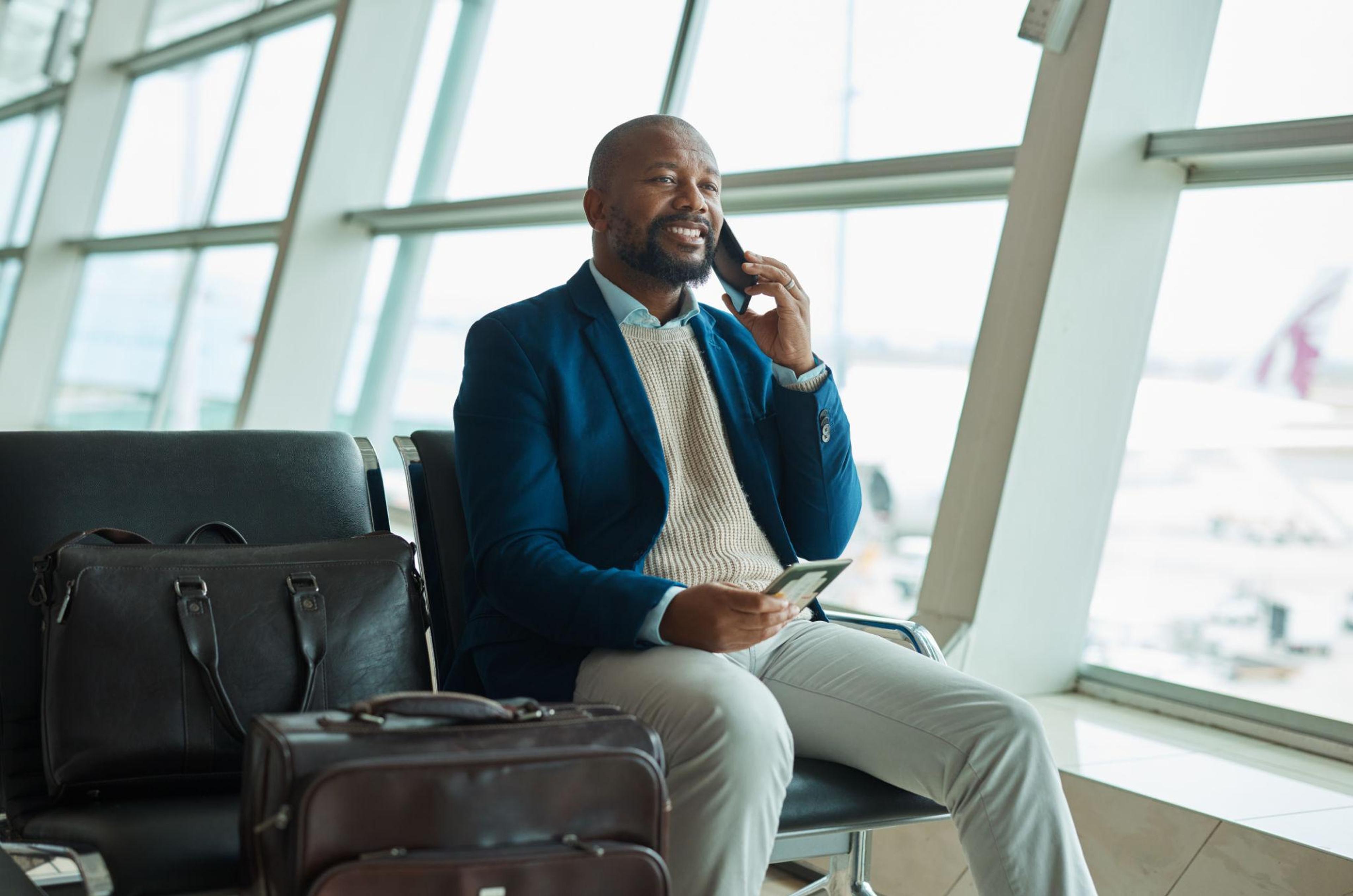 Business traveller receiving flight rebooking and travel support at an airport