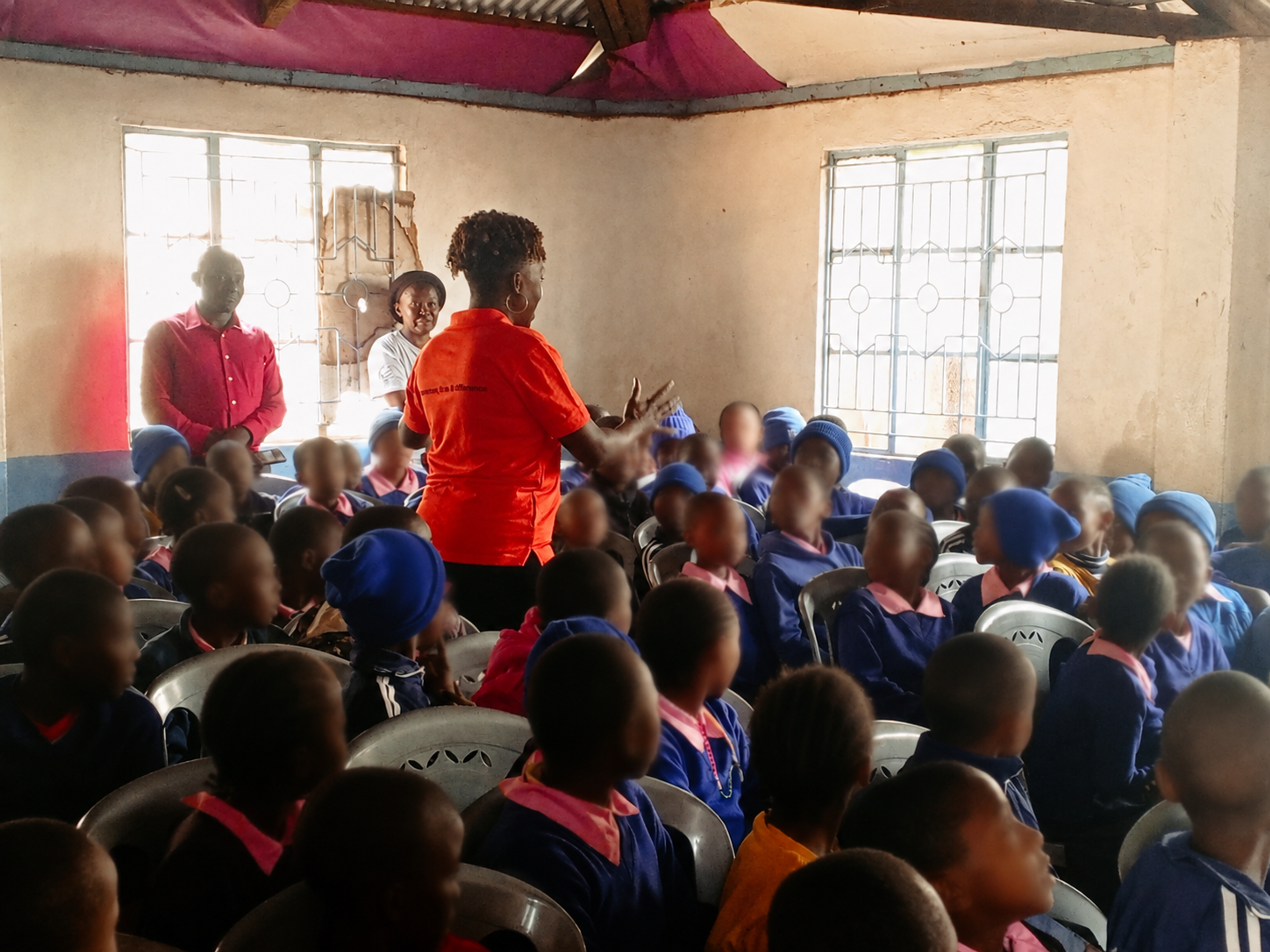 Kendirita team engaging with pupils during a community outreach visit at Kibera YMCA School