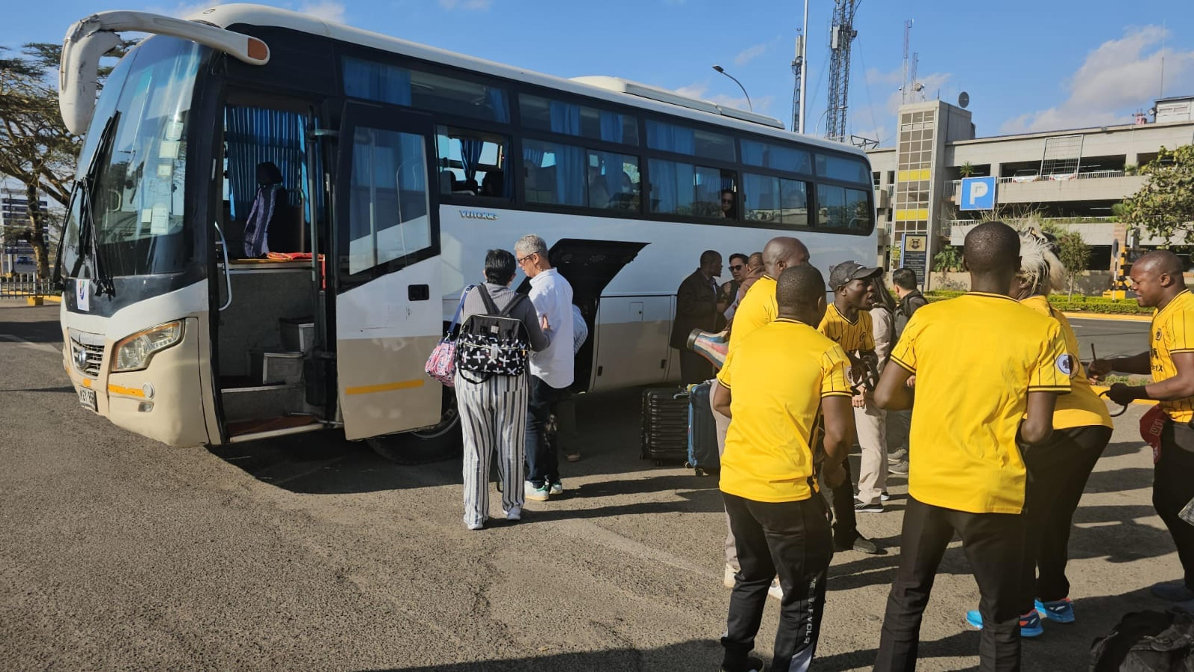 Kendirita Tours & Travel team assisting travellers with coach transport at Nairobi airport