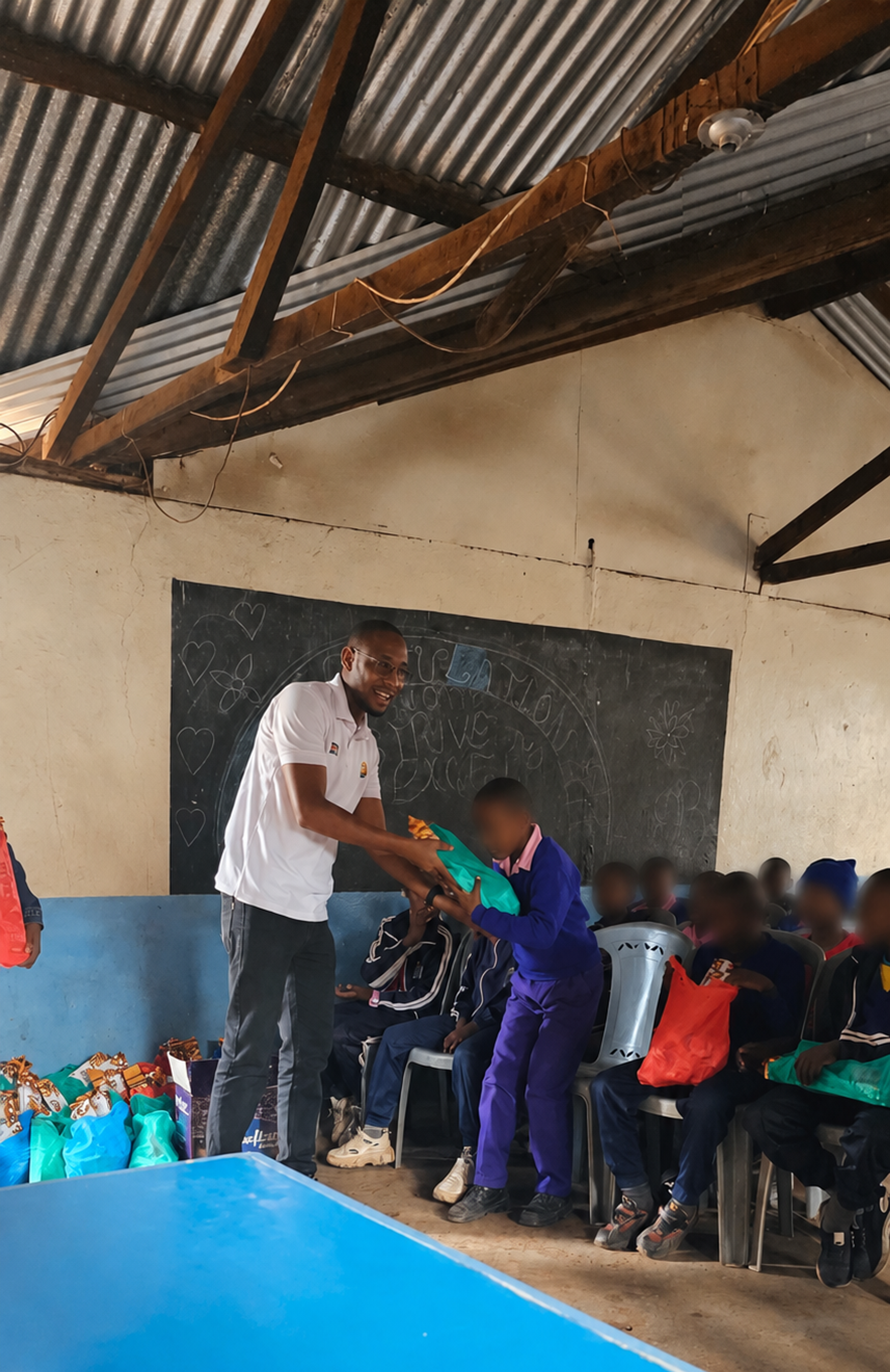 Kendirita team member distributing a care kit to a pupil at Kibera YMCA School