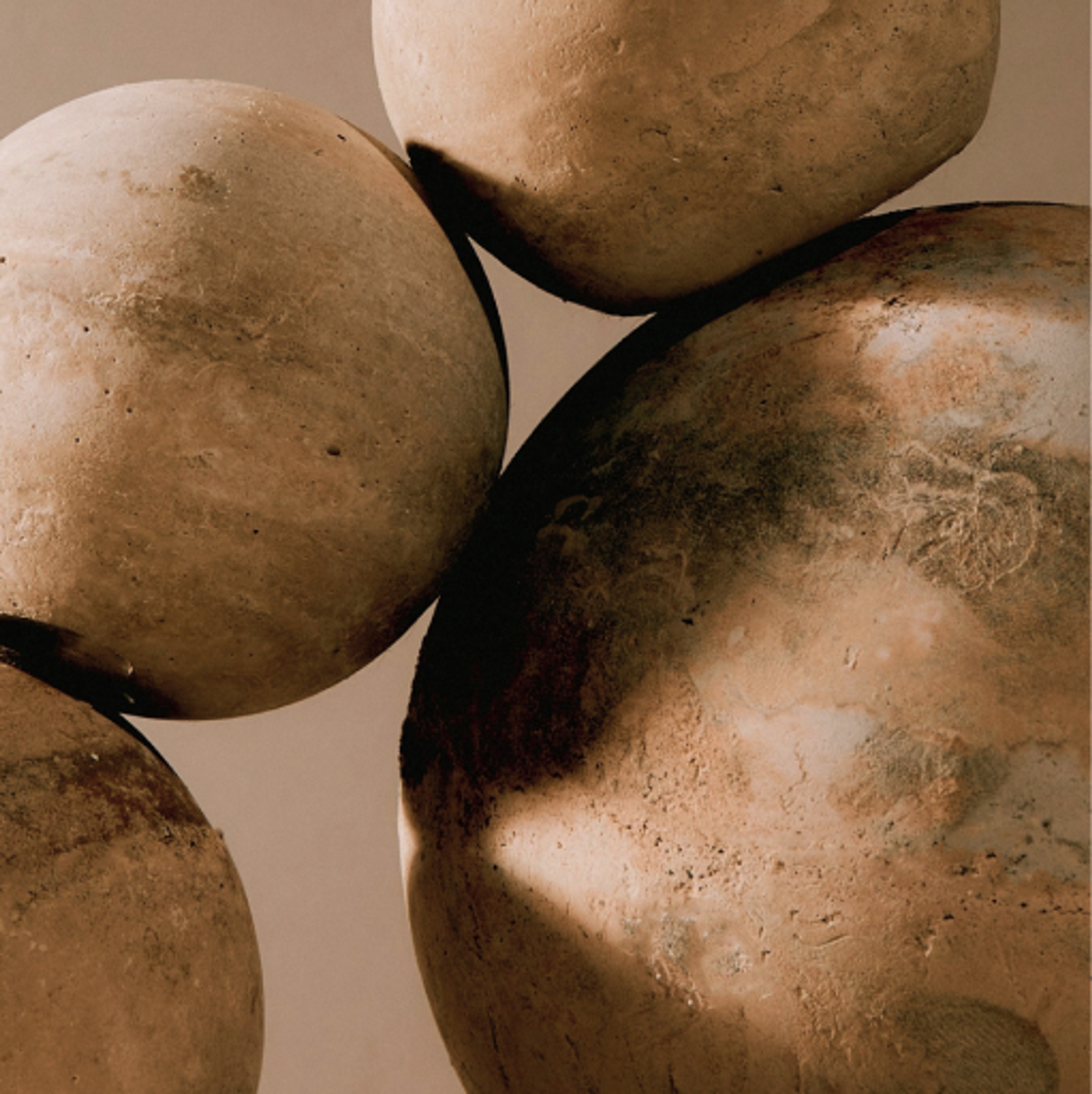 rendering of sphere shaped stones in a travertine texture. It is comprised of streaks of oranges, browns, and white hues.