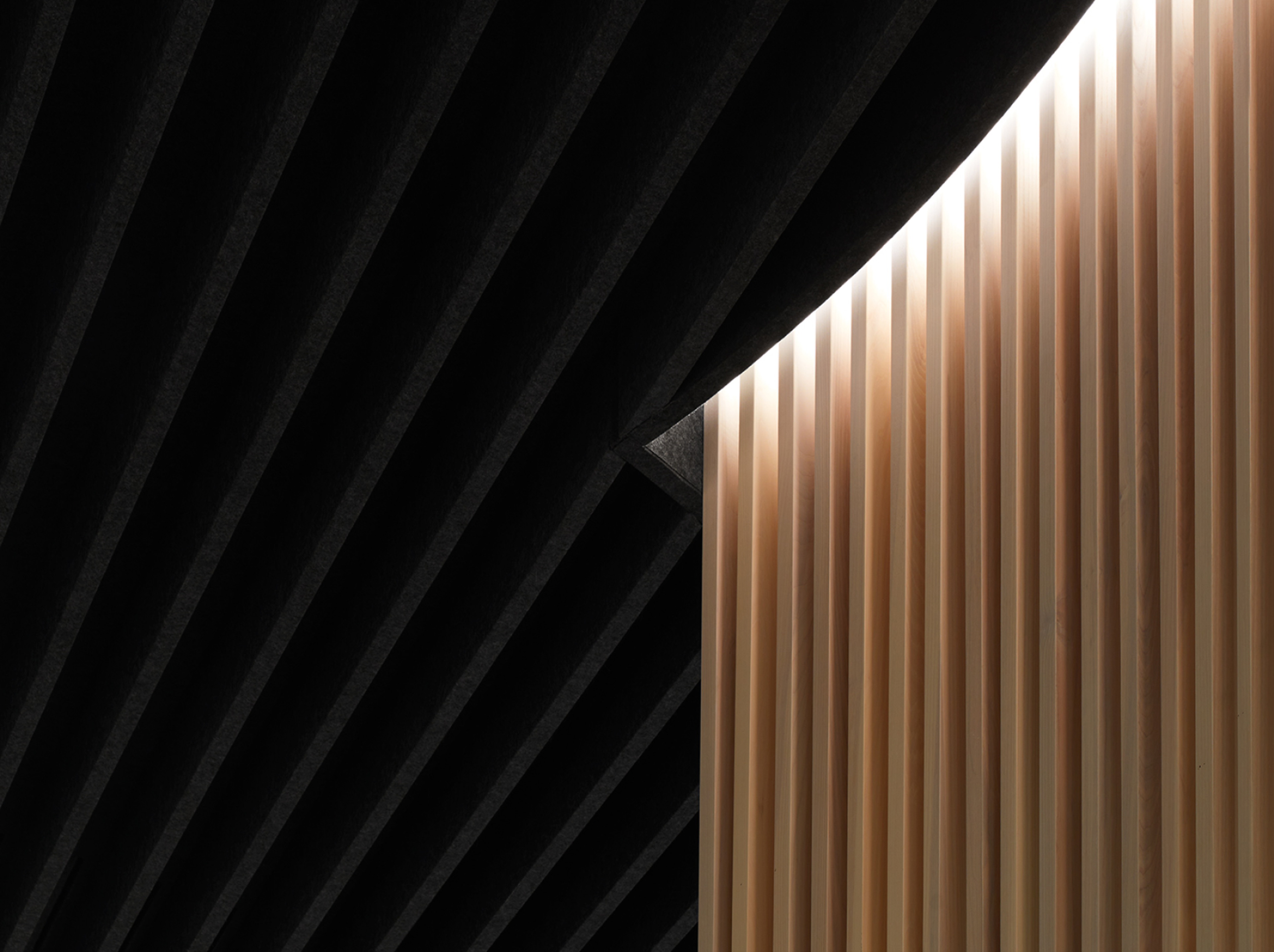 A close up of Turf's Datum baffles coordinated around a wood panel wall at Ever Restaurant.