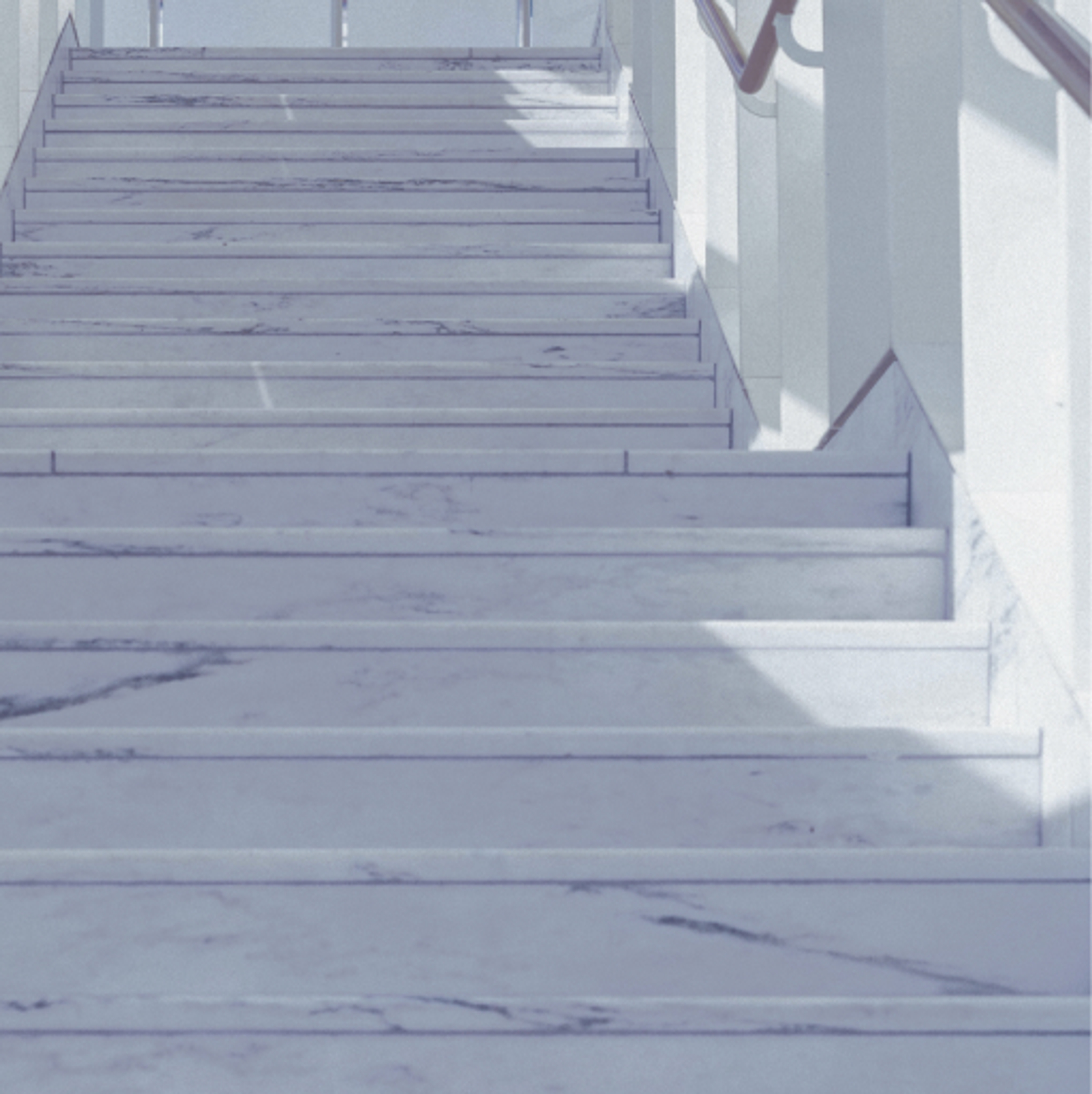 A close up view of white marbled stairs in a building.