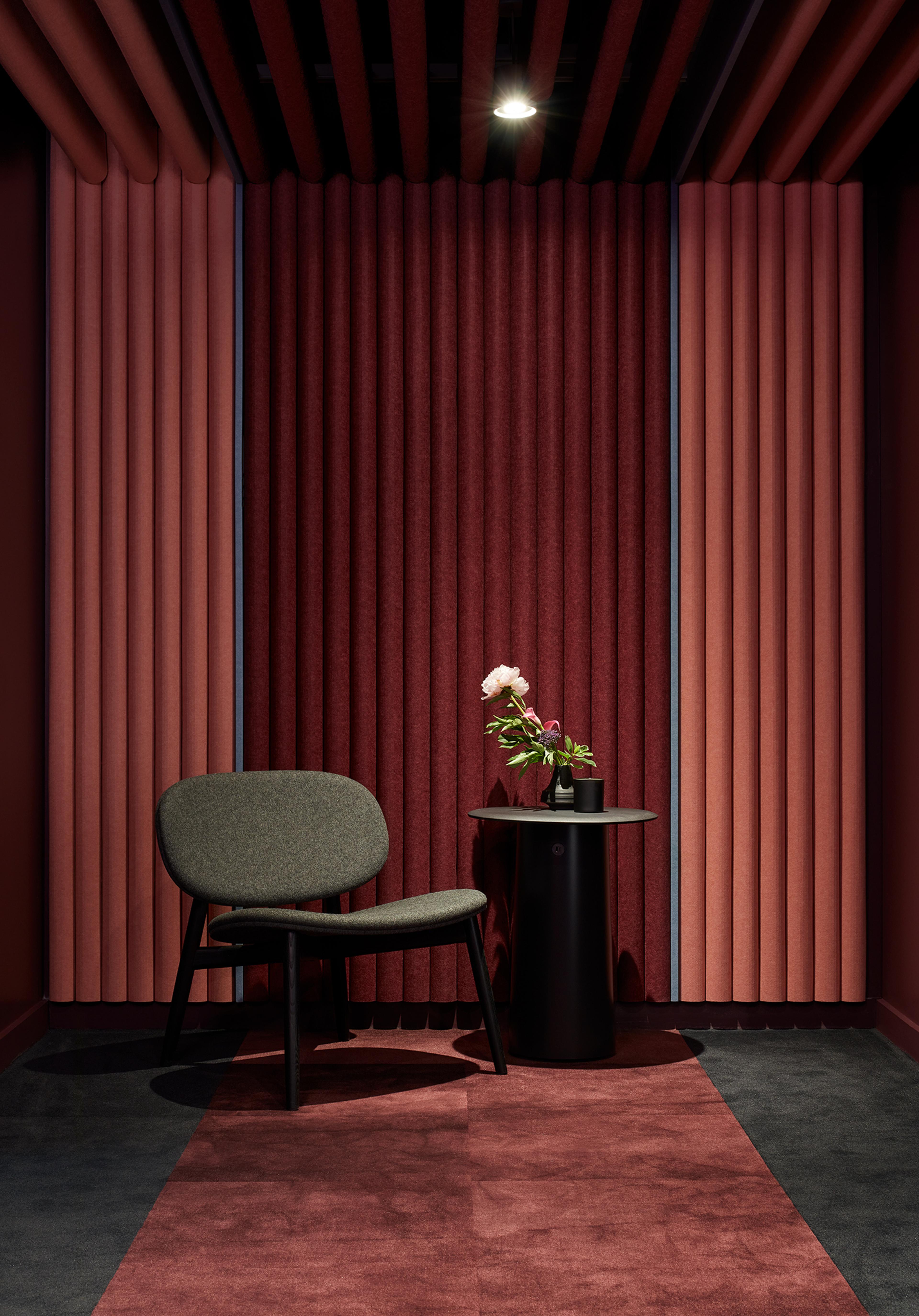 Turf's 2023 NeoCon showroom with red and pink Turf Reed acoustic paneling.