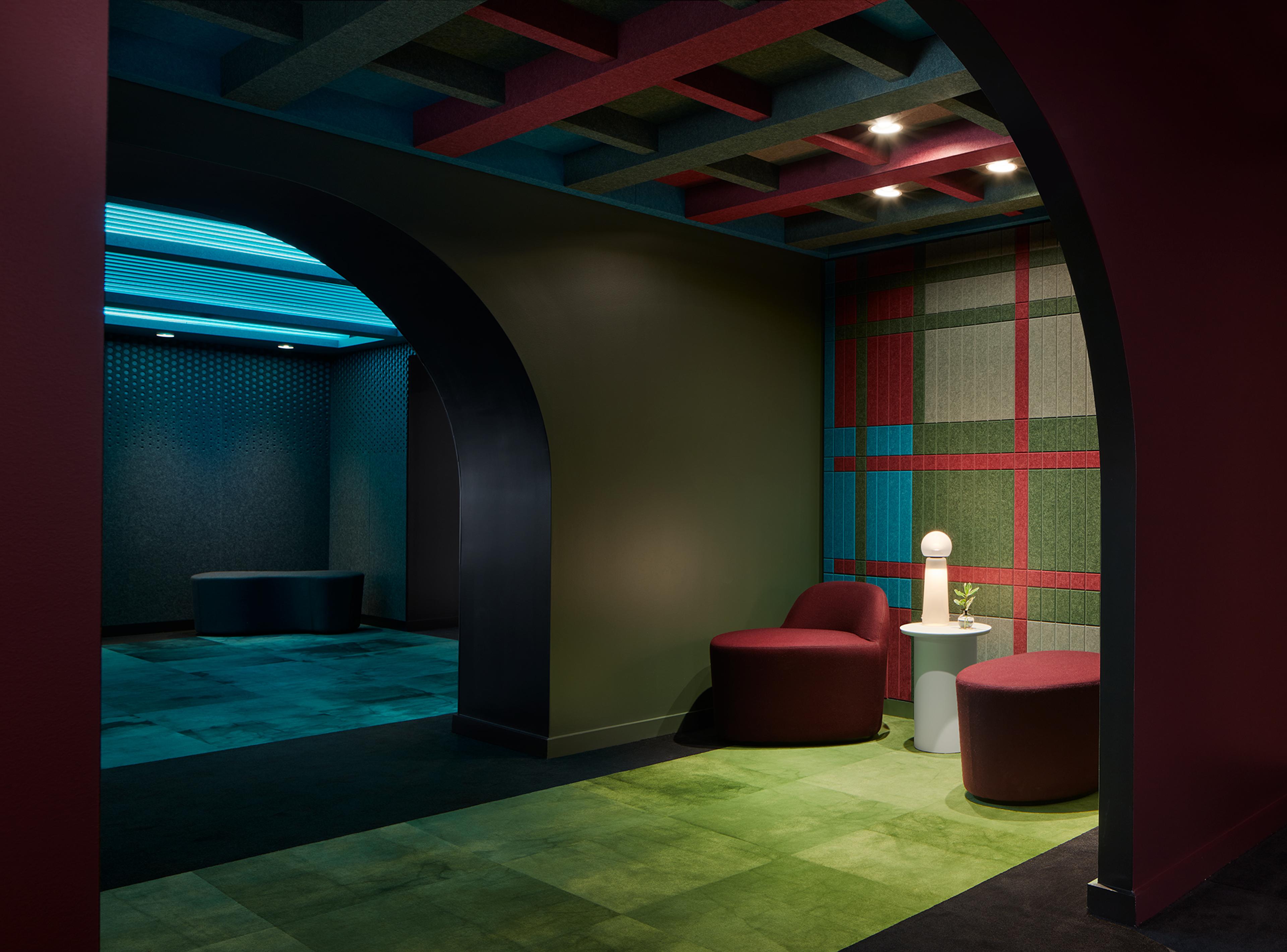 Turf's 2023 NeoCon showroom with colorful  green, blue, and red ceiling and wall acoustic installations.