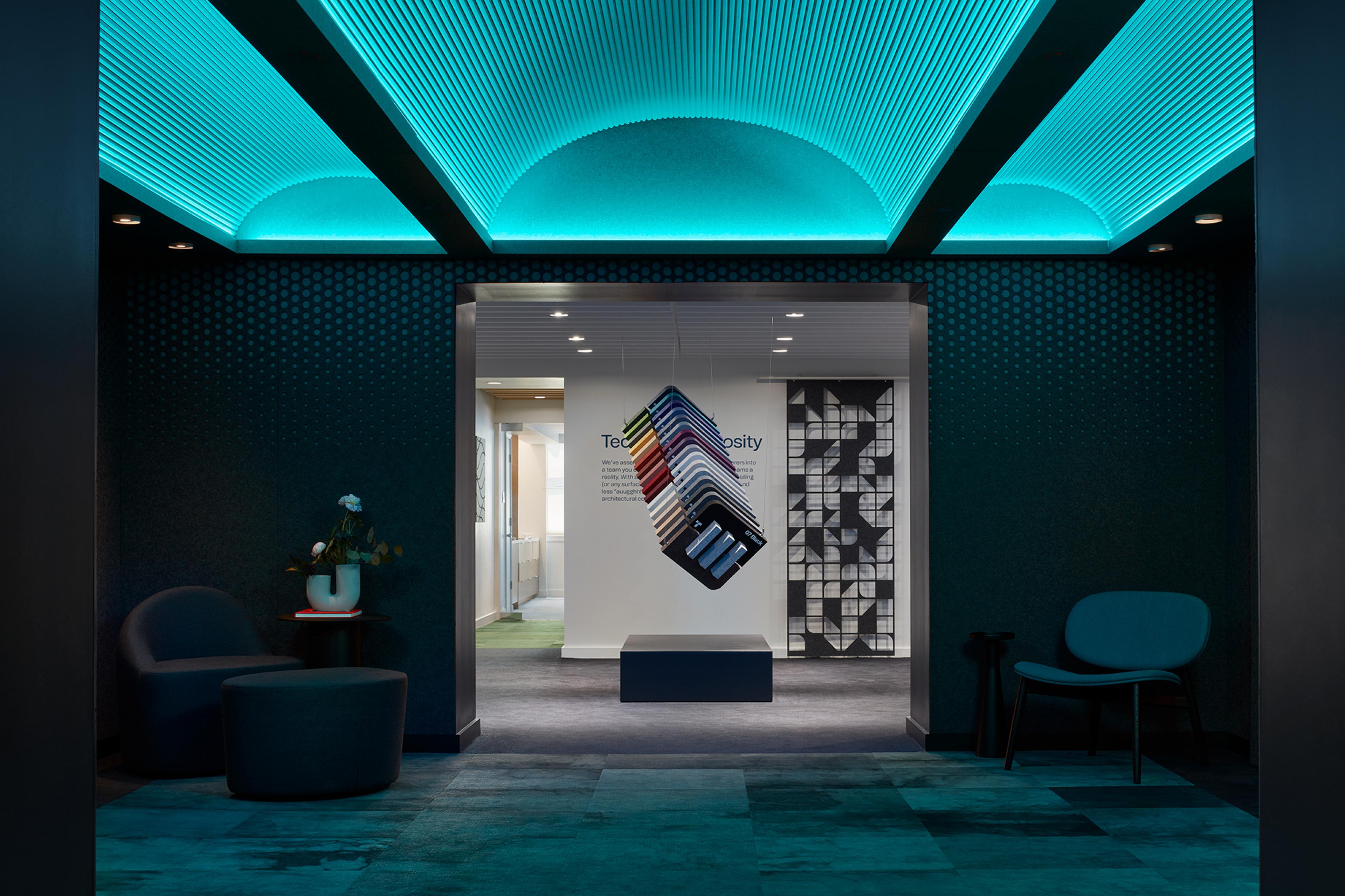 Turf's 2023 NeoCon showroom with ceiling and wall installations in cyan blue color.