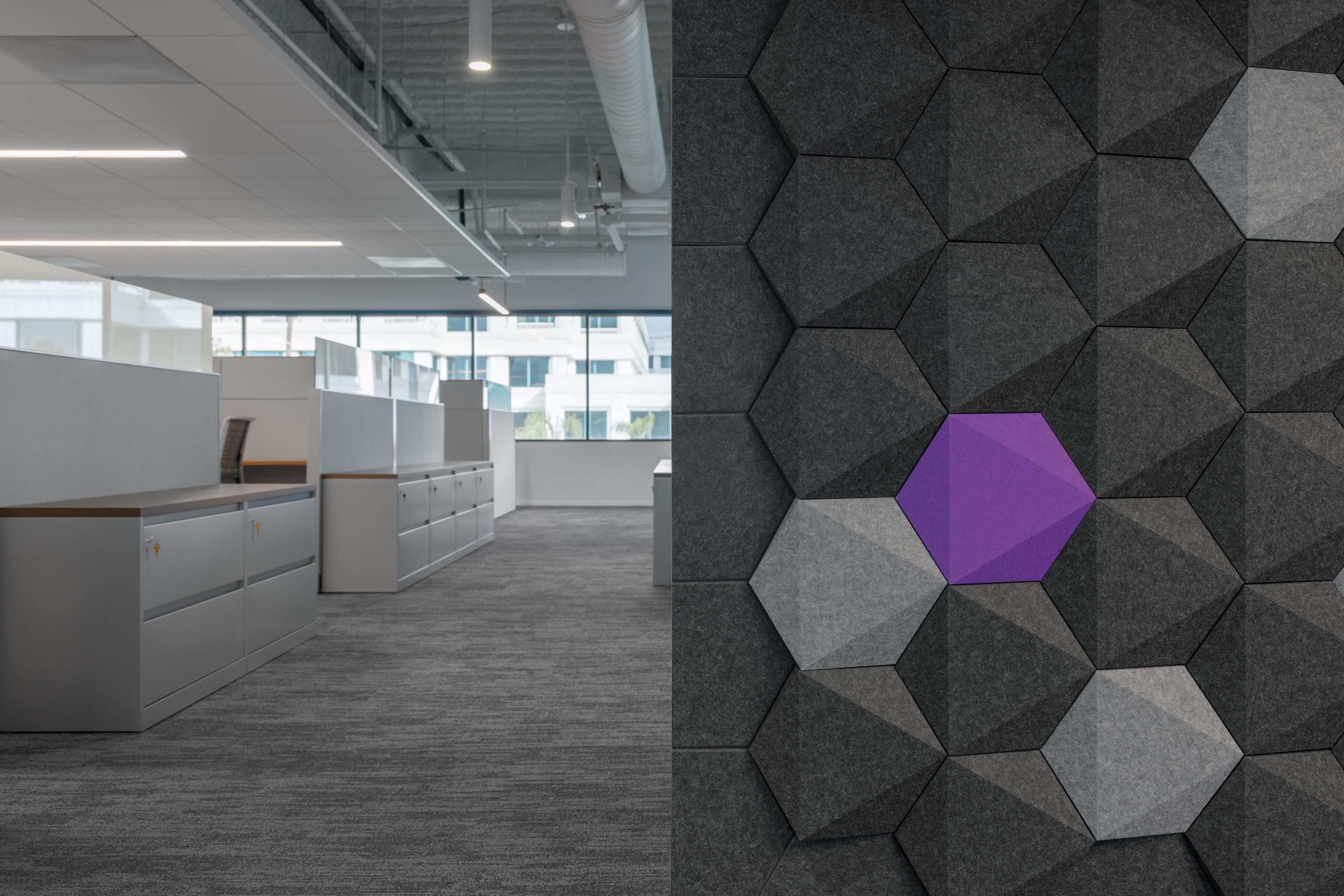 A close up of Turf's Hex acoustic wall tiles in purple, grey, charcoal.