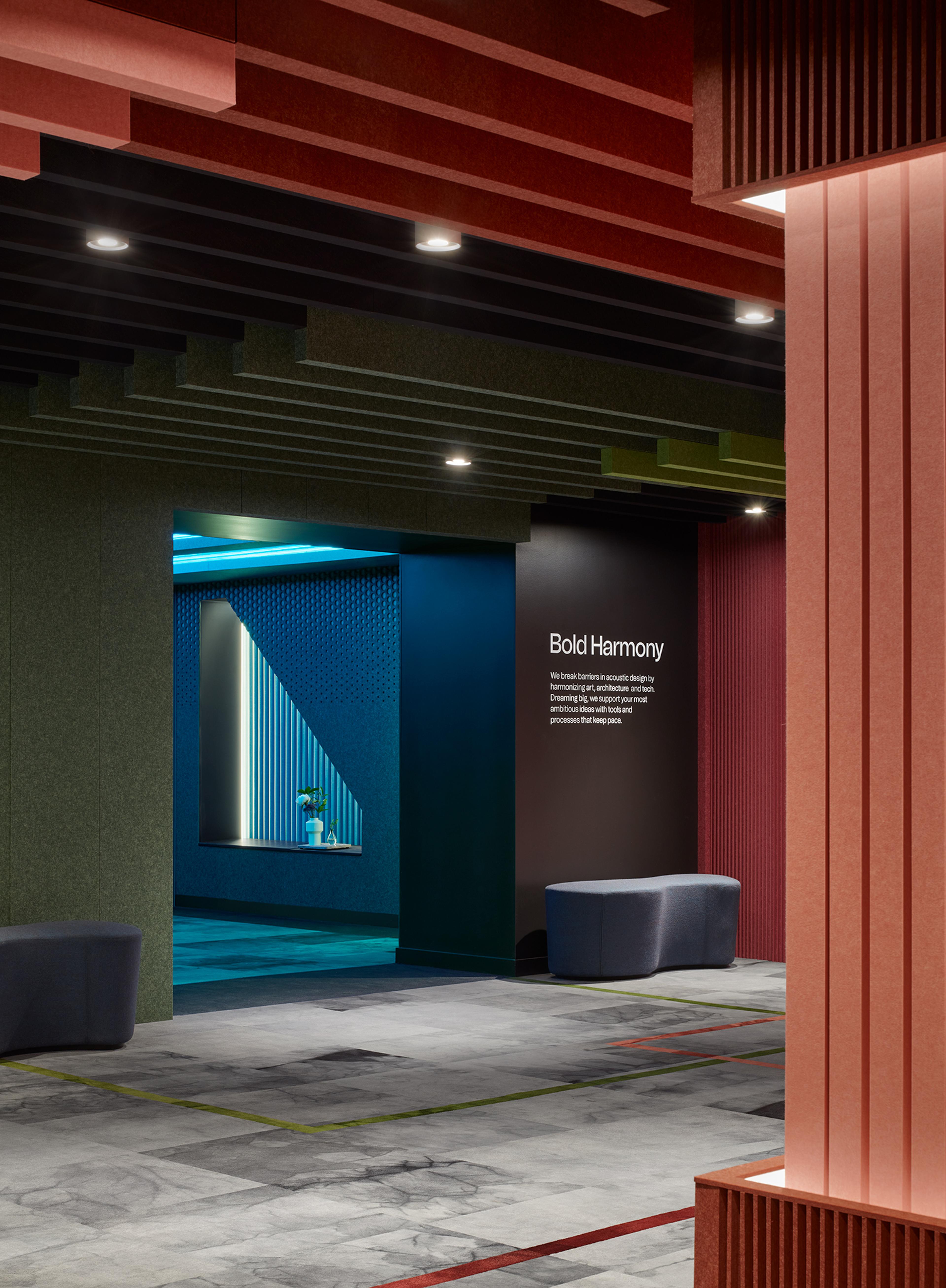 Turf's 2023 NeoCon showroom with ceiling and wall acoustic installations in pink, red, green, and blue.