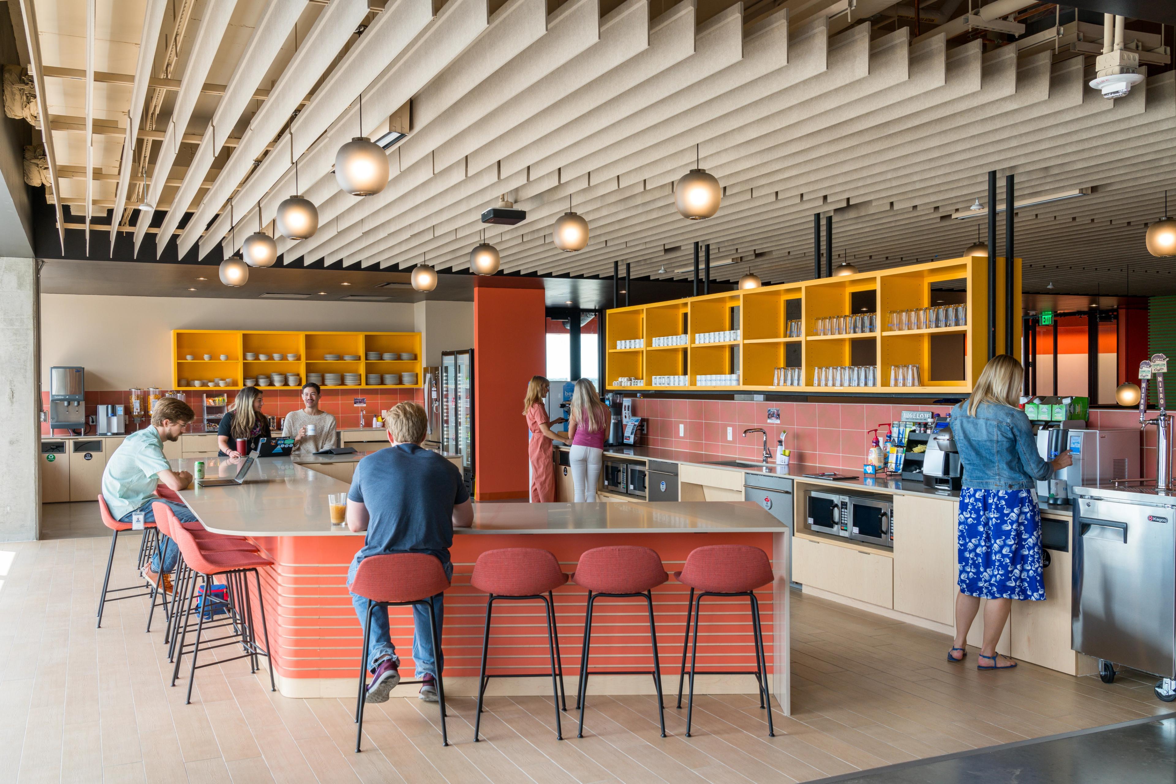 Turf's Straight acoustic ceiling baffles on the ceiling at VRBO's office kitchen in Austin.