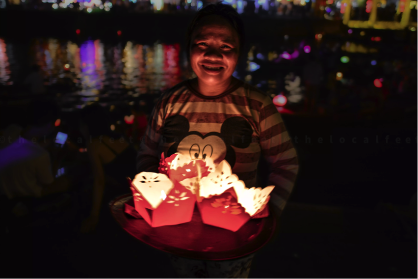 A happy face with the flower shaped Lanterns made of paper