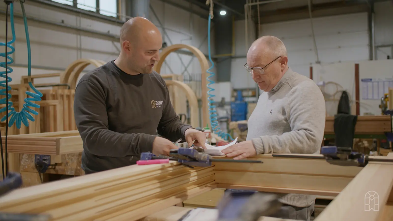 Mumford and wood team members in factory