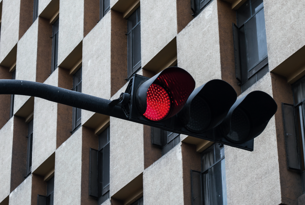 Close up of a red stoplight in front of a building
