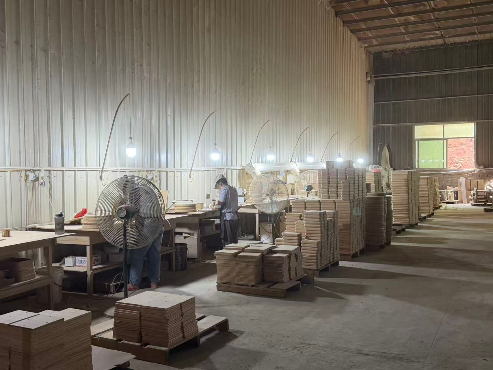 Overseas buyers touring timber raw material storage warehouse of China furniture factory, stacked solid wood veneer boards for sofa and cabinet production