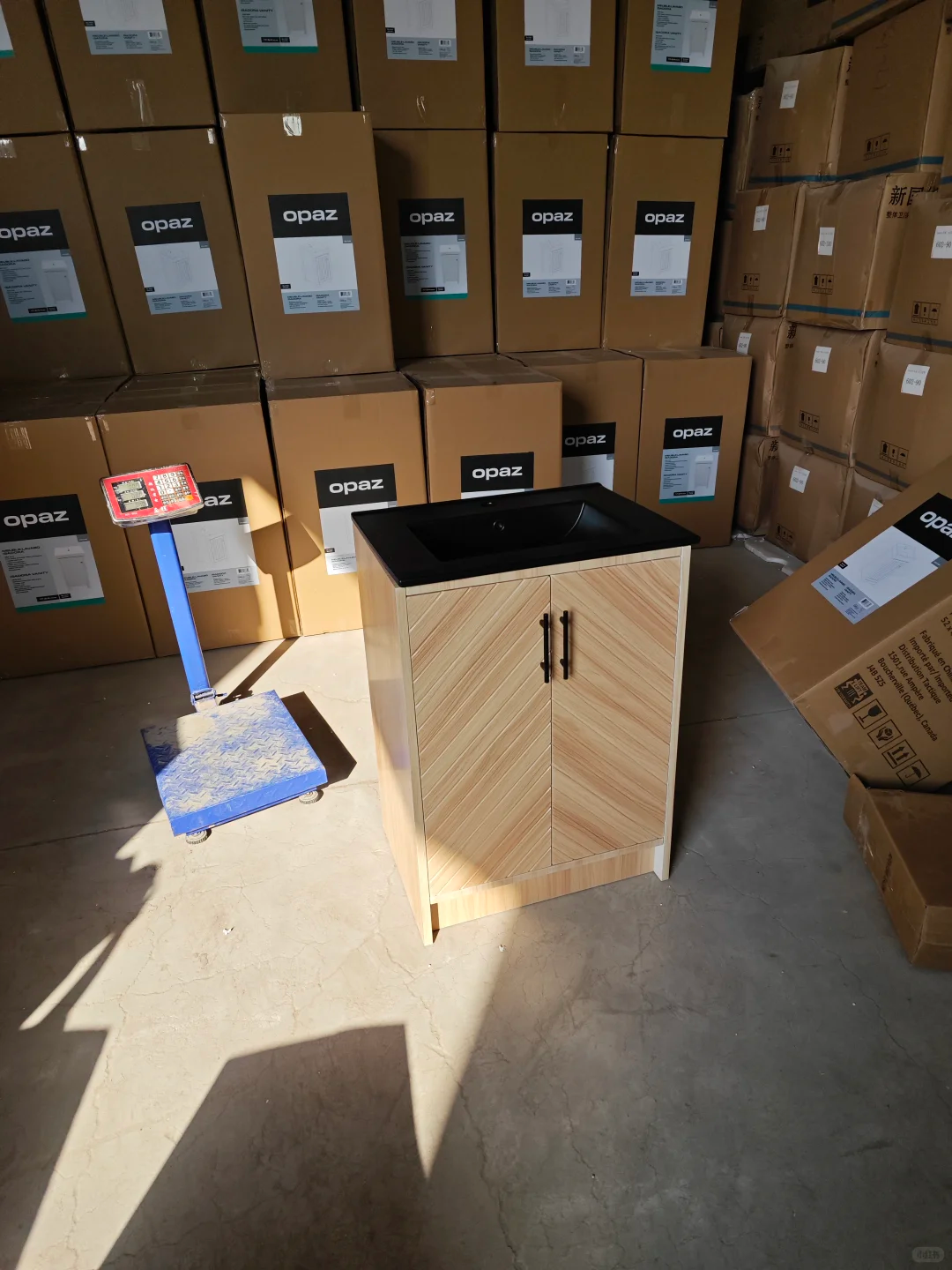 Warehouse QC check of finished bathroom vanity units and export packaging boxes before shipment
