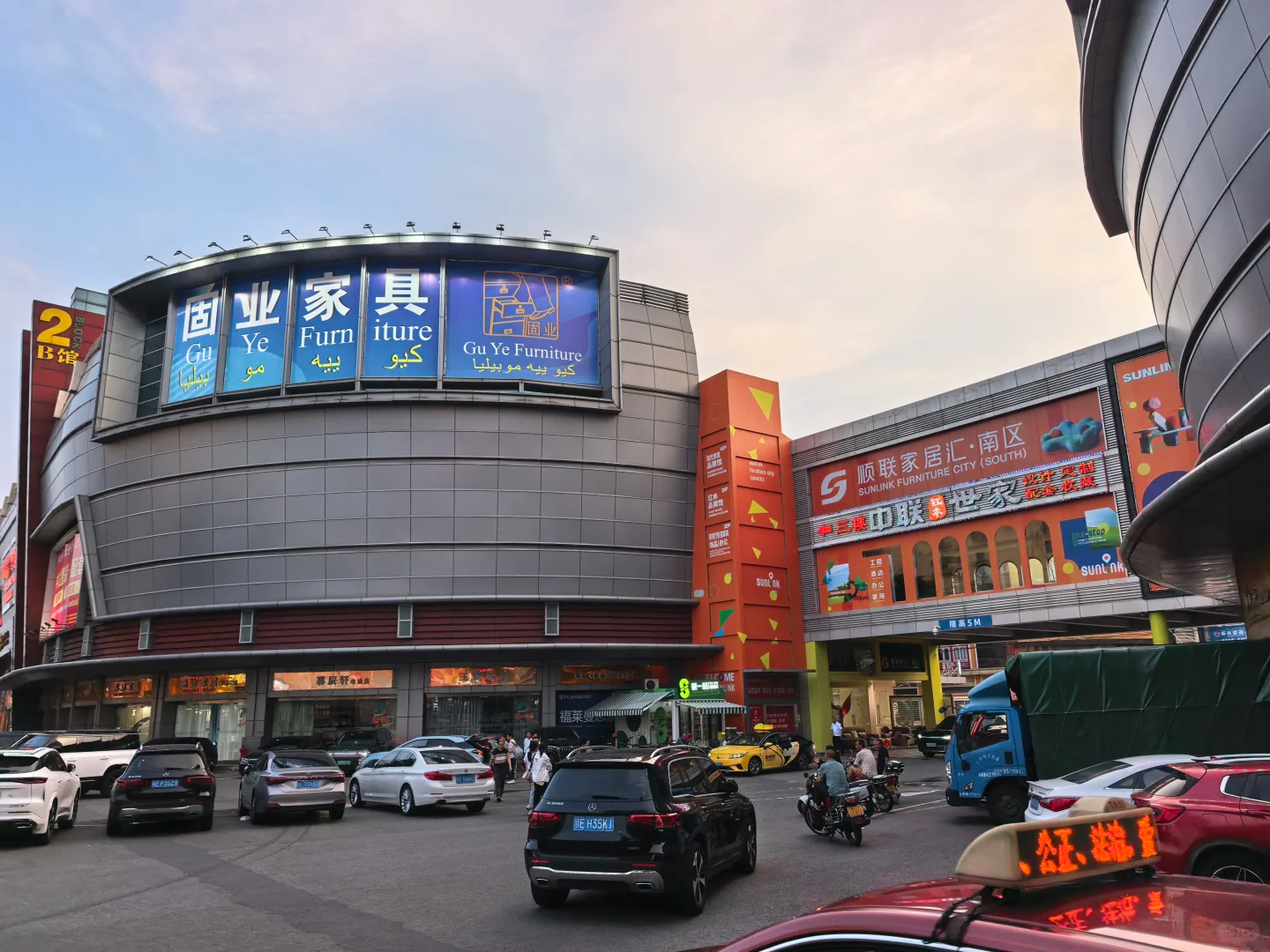 Wide street view of multiple furniture shopping mall facades at Lecong Foshan furniture wholesale market for international purchasers