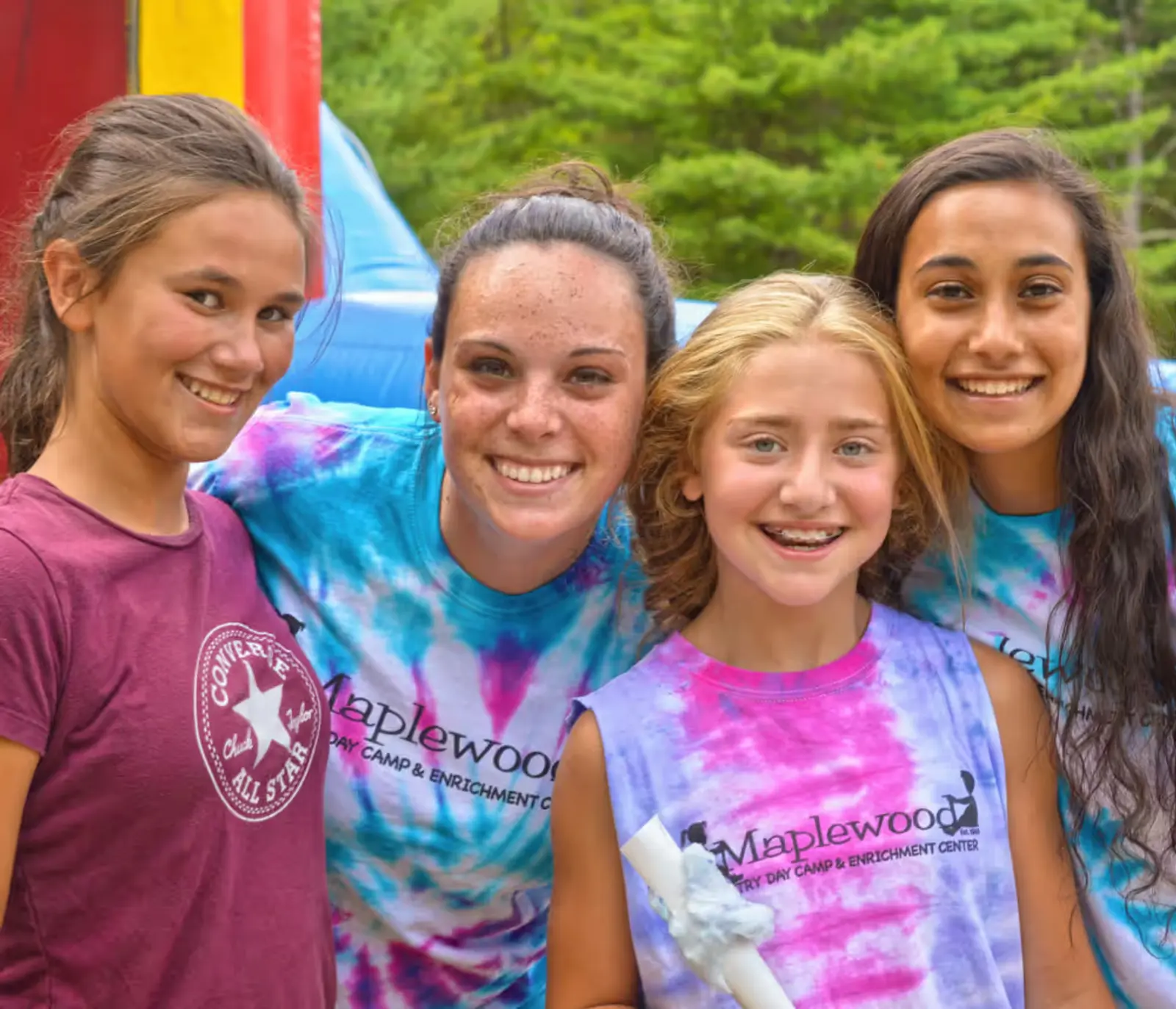 A group of young girls standing next to each other