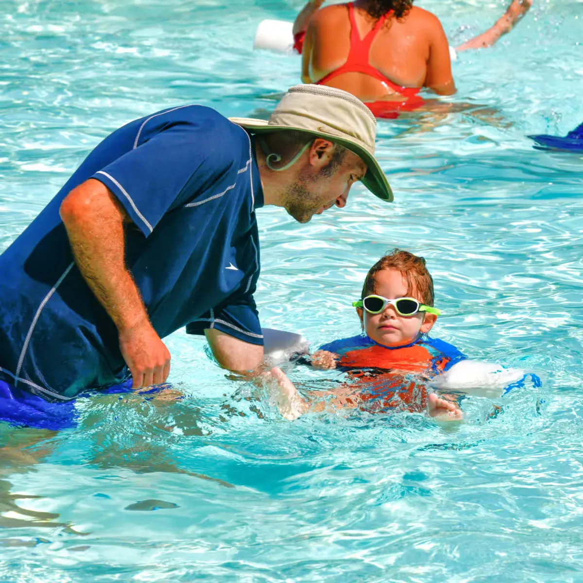 Lee Pinstein Maplewood Director teaching a camper how to swim in one of the heated swimming pools