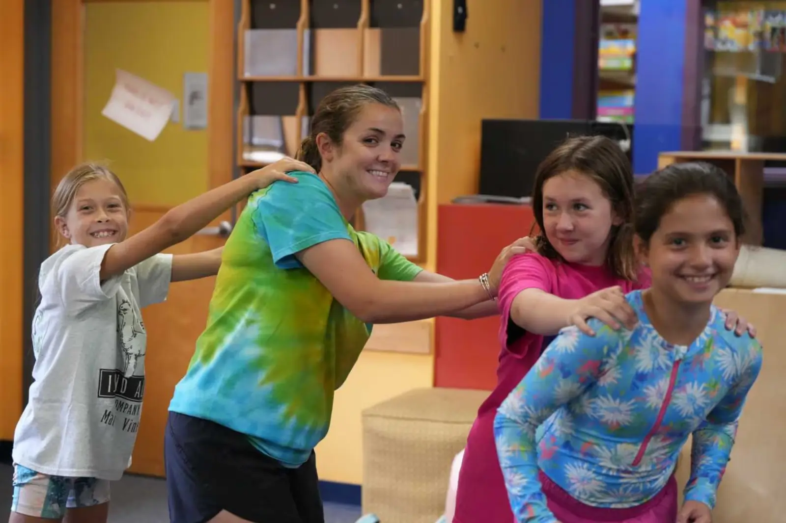 A group of young girls playing with a Maplewood counselor.