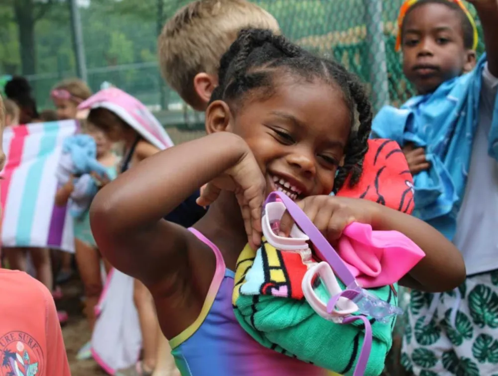 A group of young children standing around each other