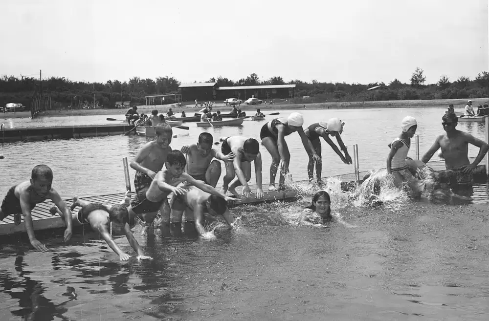 A group of people are playing in the water