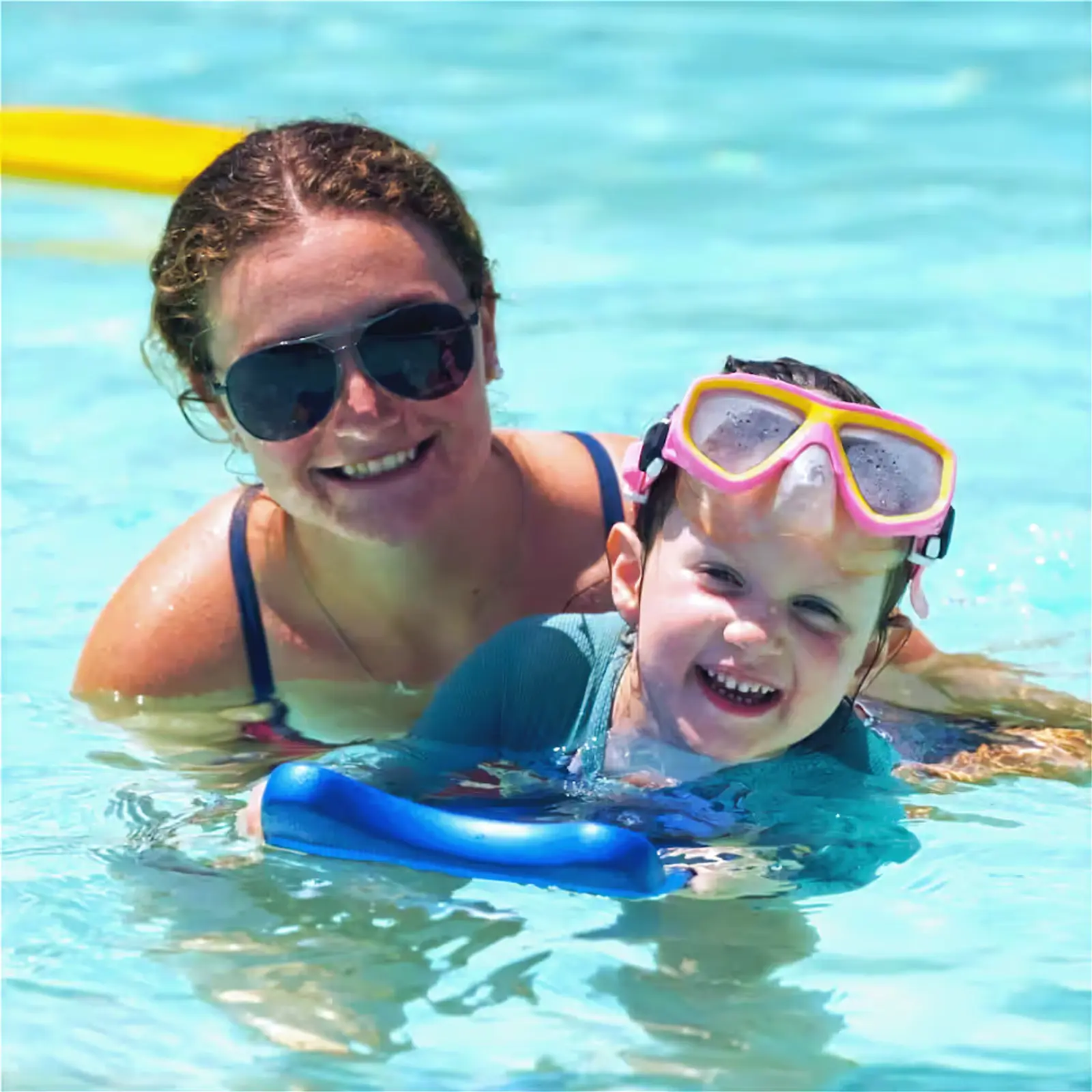 A woman and a child swimming in a pool