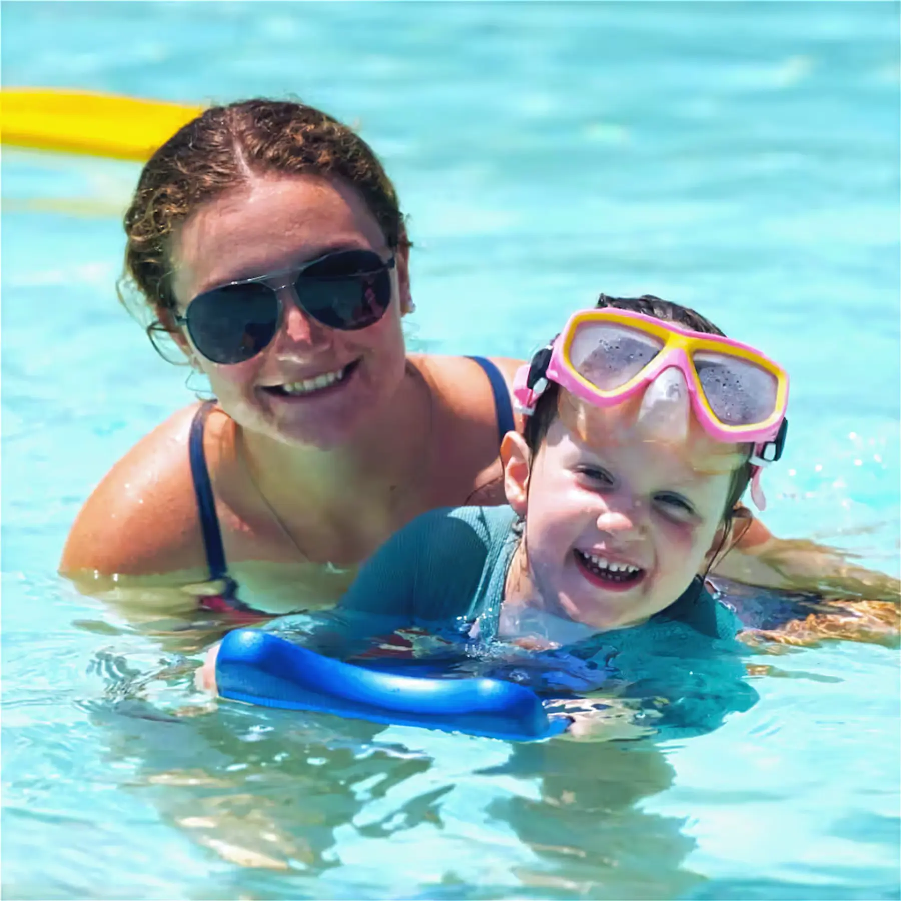 A woman and a child swimming in a pool