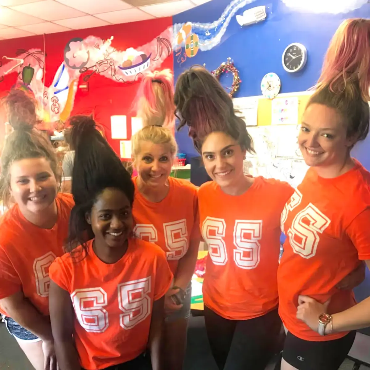 A group of young women standing next to each other