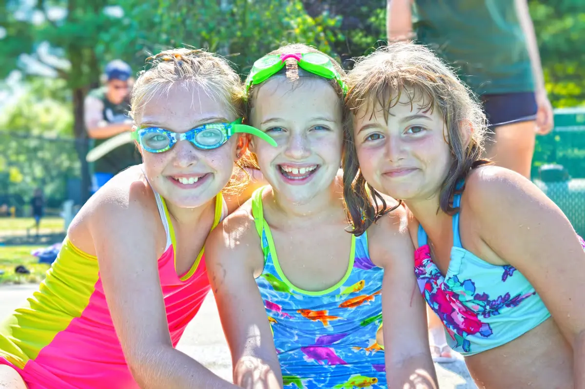 Three young girls sitting next to each other