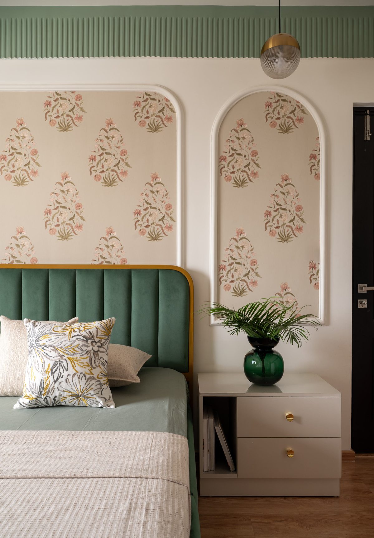 Green velvet headboard against floral wallpaper, Project Saaj
