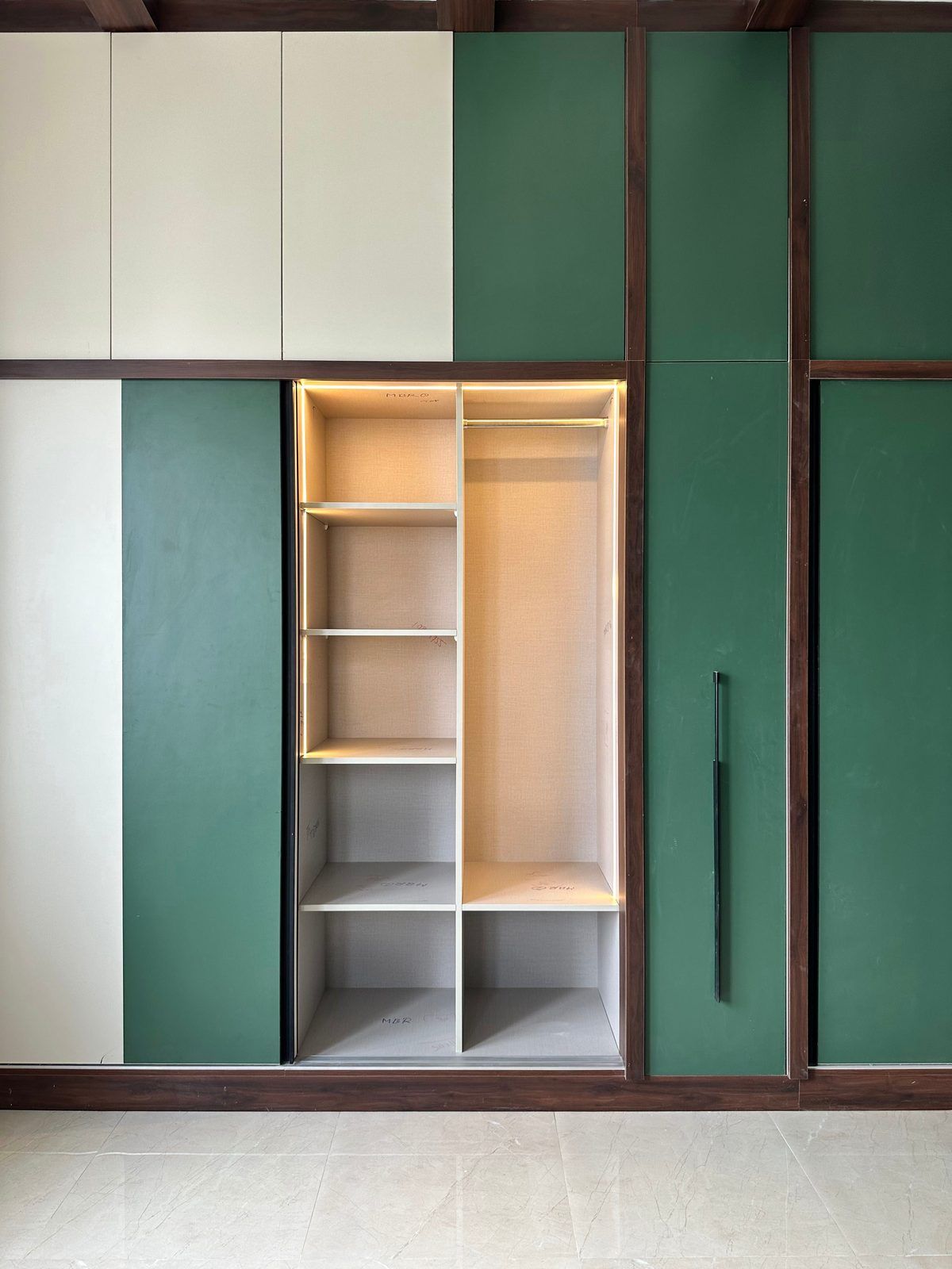 Emerald wardrobe with warm-lit open shelving, Project Rasa