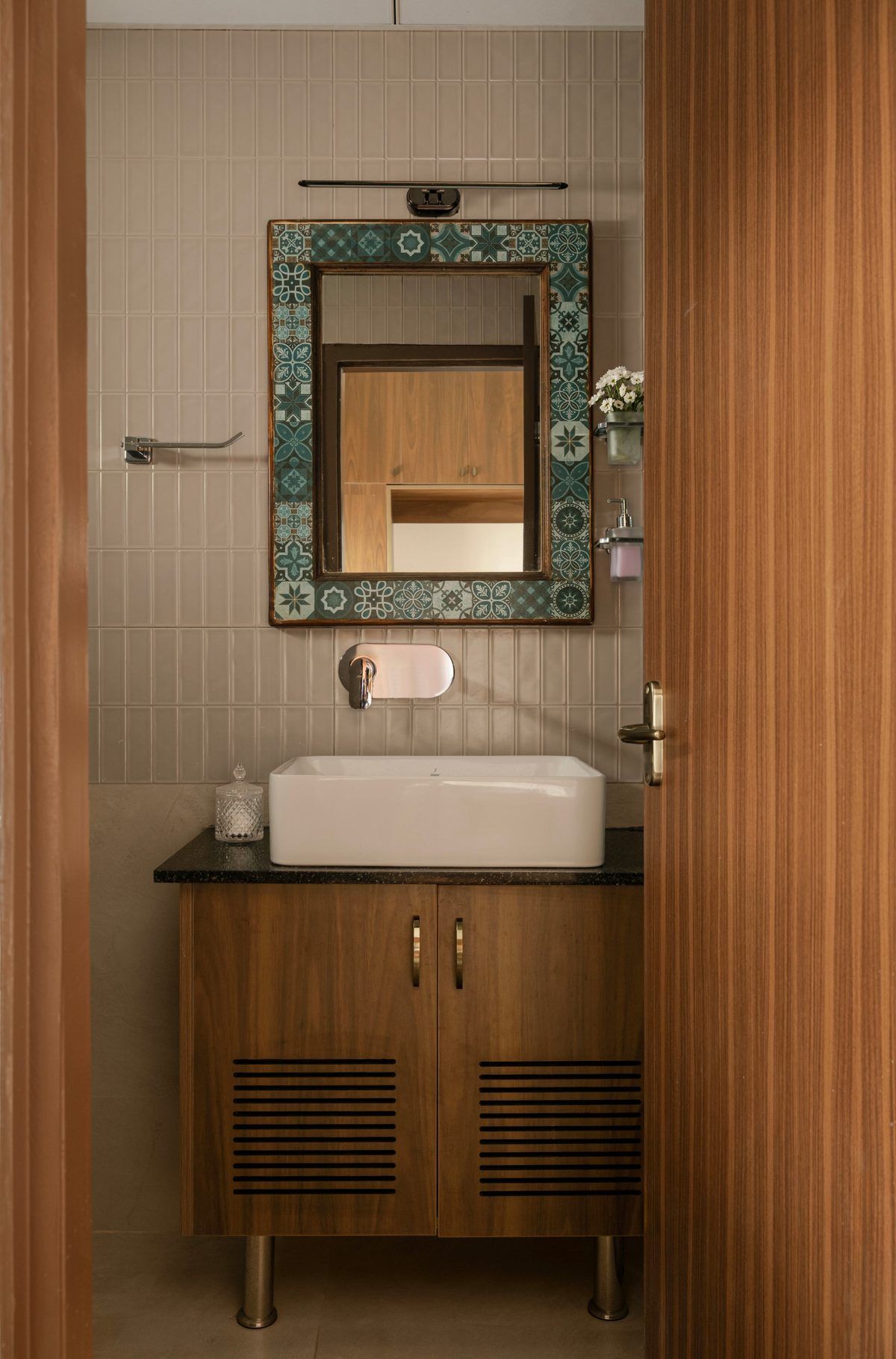 Ribbed wood-tone vanity with framed mirror and ceramic basin