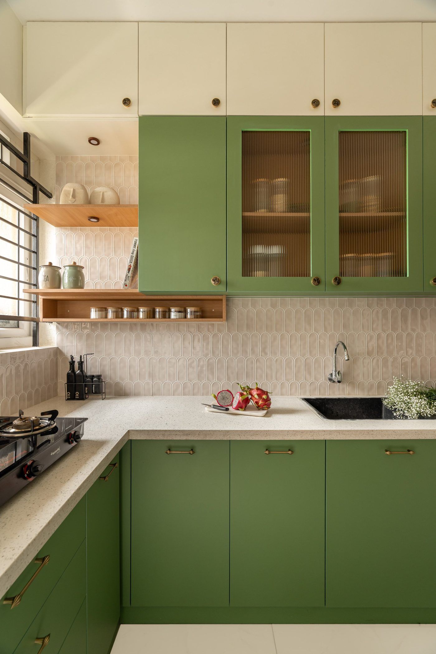 Olive green U-shaped kitchen with marble splashback