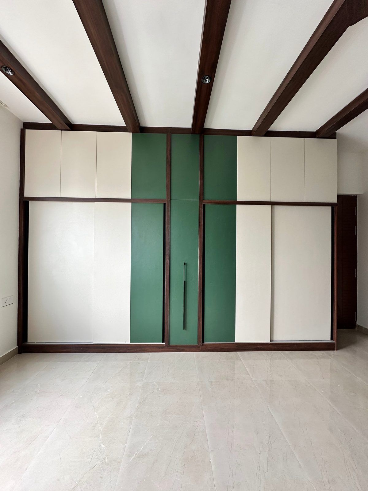 White and sage wall units under exposed beams.