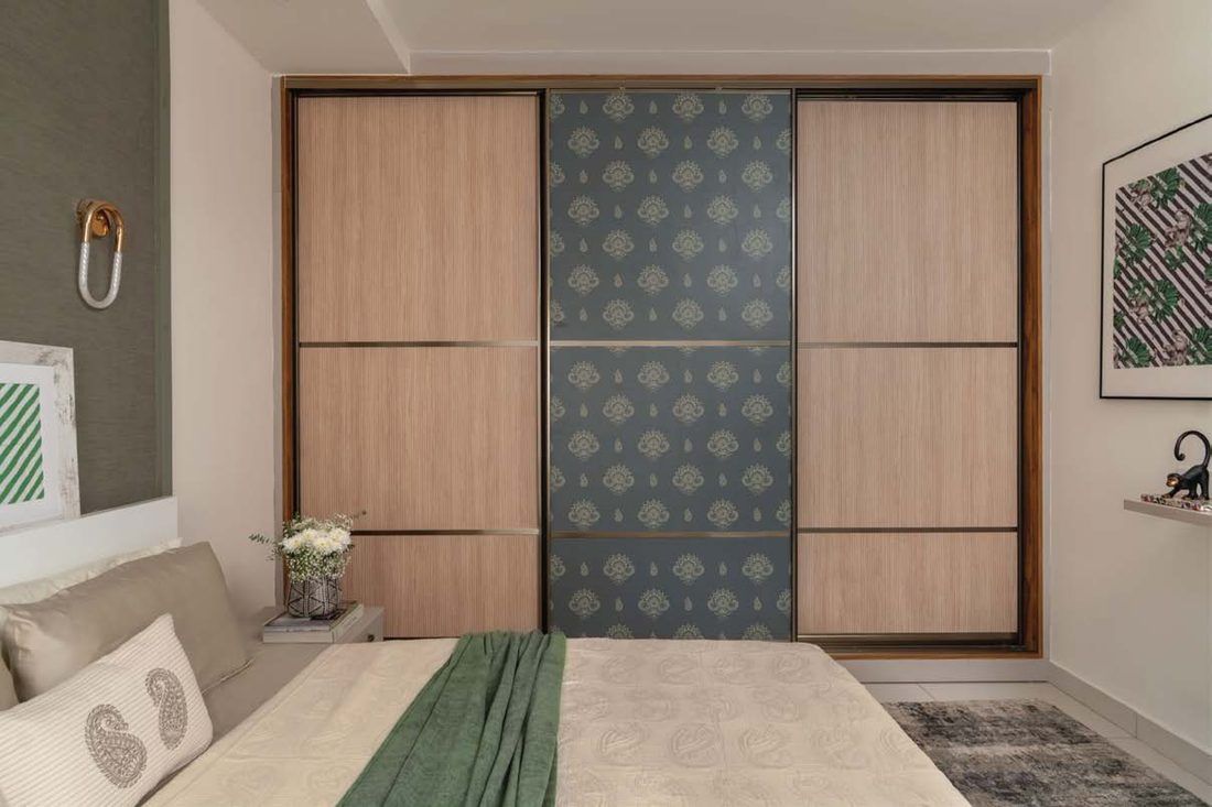 A wide sliding wardrobe with bronze-framed doors