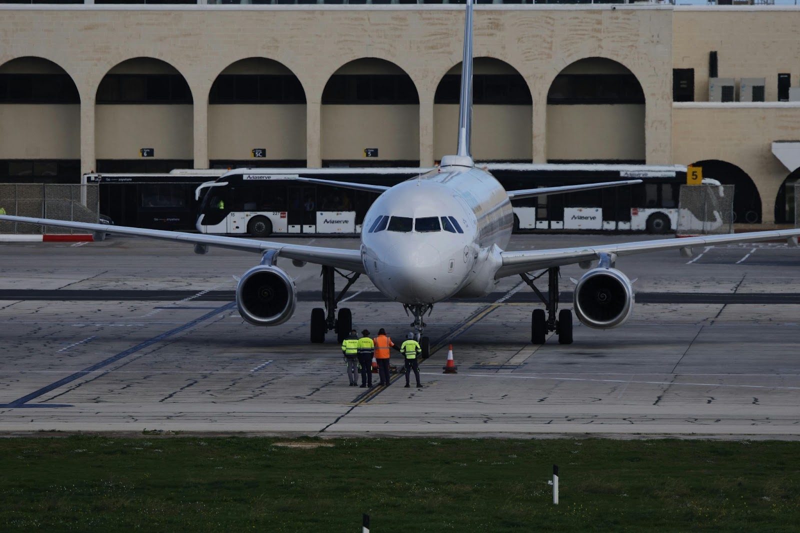 A commercial aircraft at the airport taxiway with ground crew preparing for movement. The image highlights the urgency of AOG response, where rapid maintenance decisions and AI-driven logistics can significantly reduce costly delays.